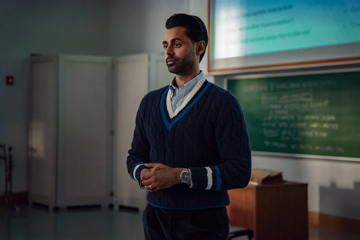 Hasan Minhaj stands at the front of a college classroom.