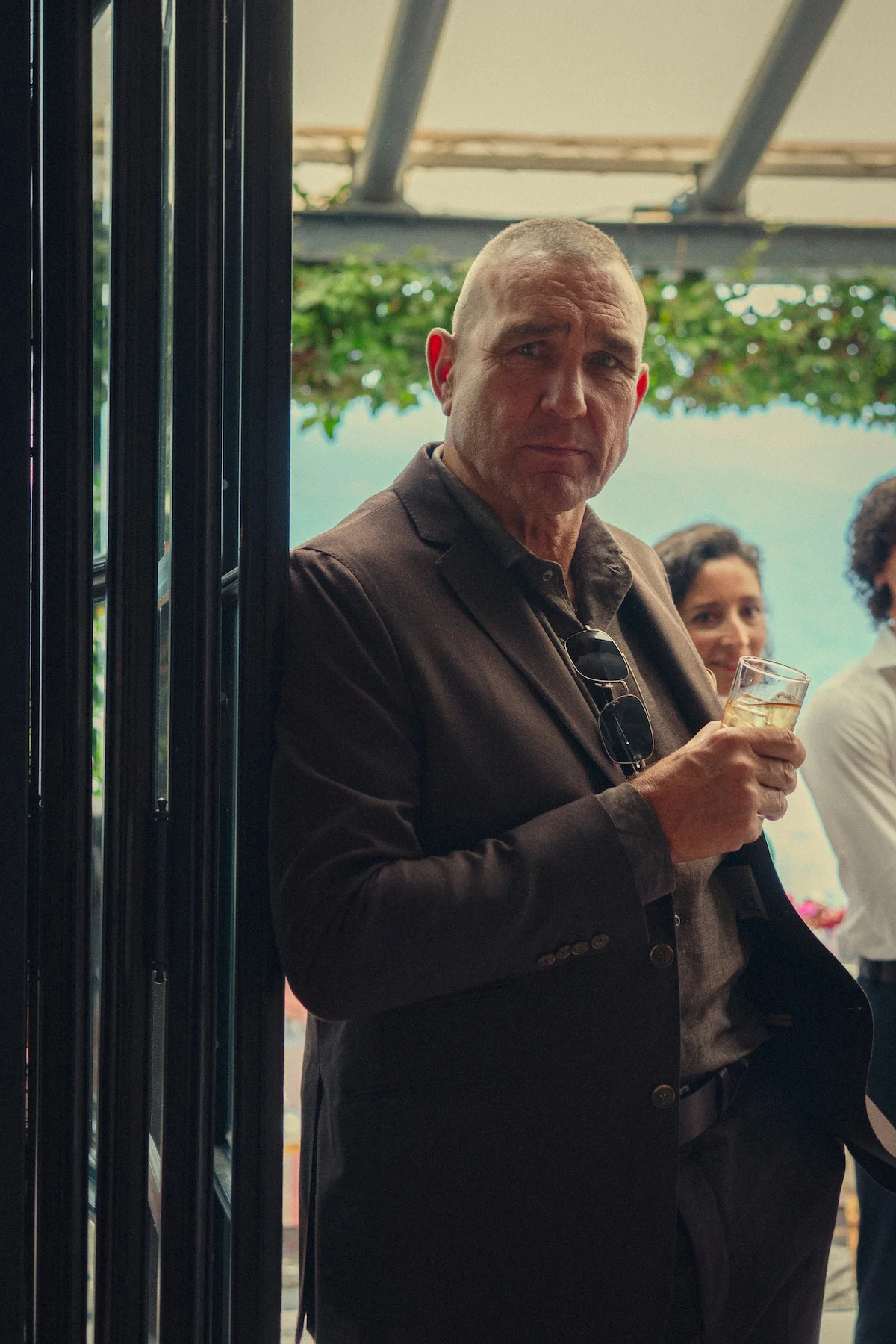 Vinnie Jones poses in a brown suit during promotion for The Gentlemen Season 2.