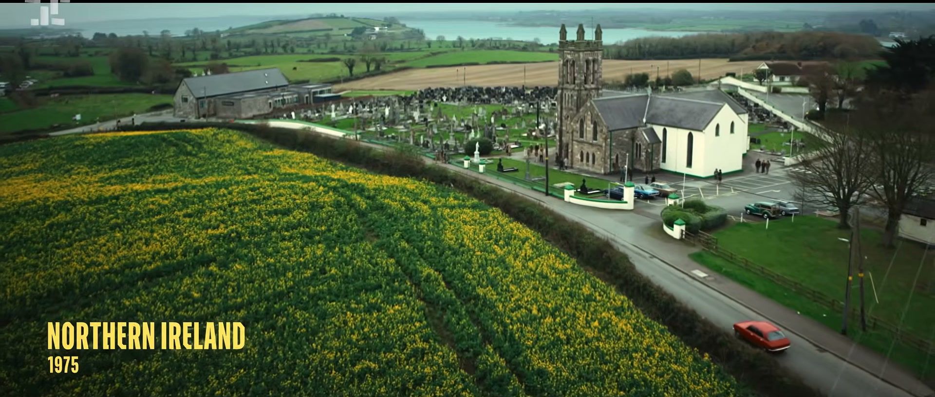A church and green fields establish Northern Ireland in 1975 at the start of Trespasses.