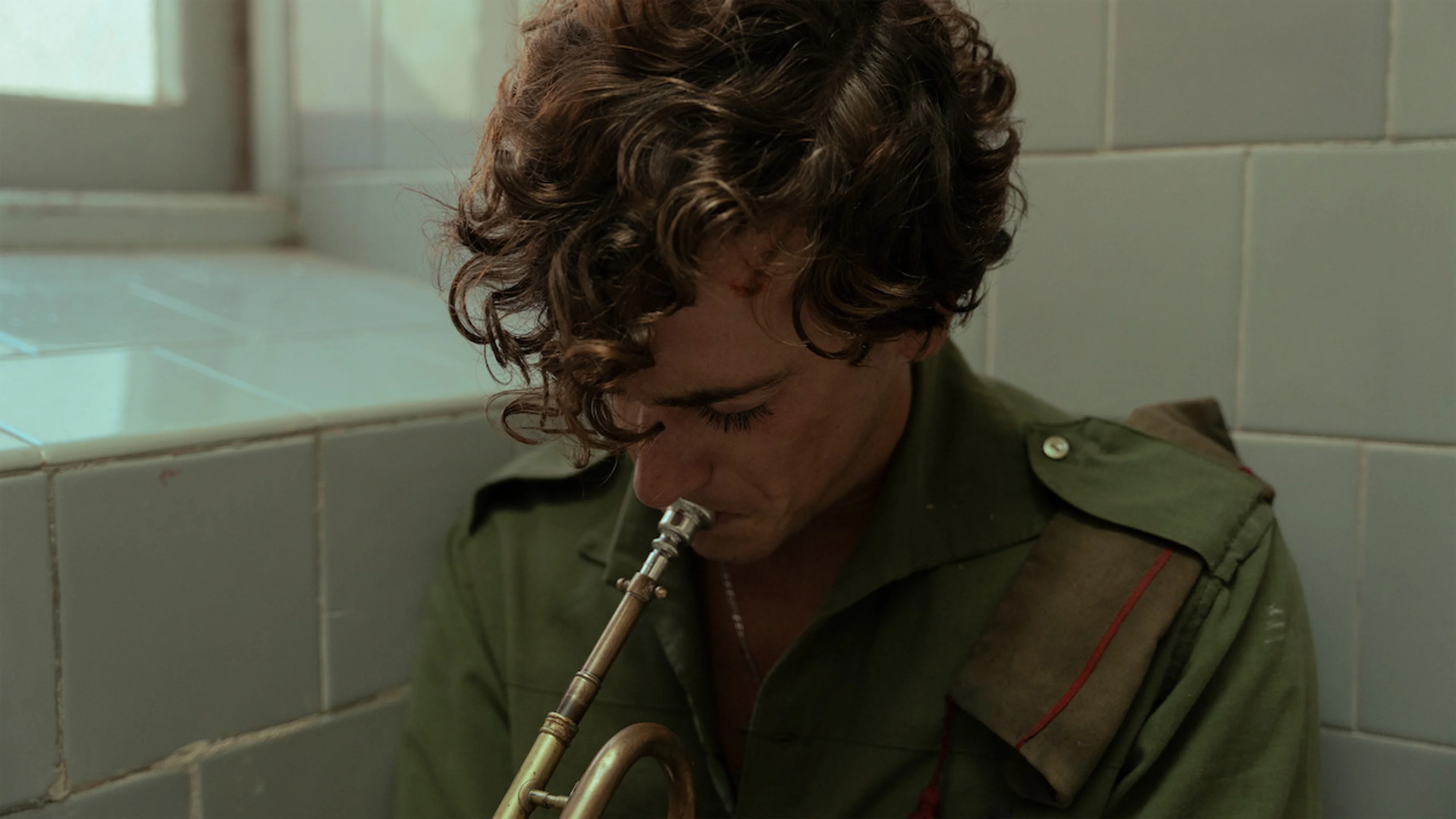 A soldier plays trumpet in La Bola Negra.