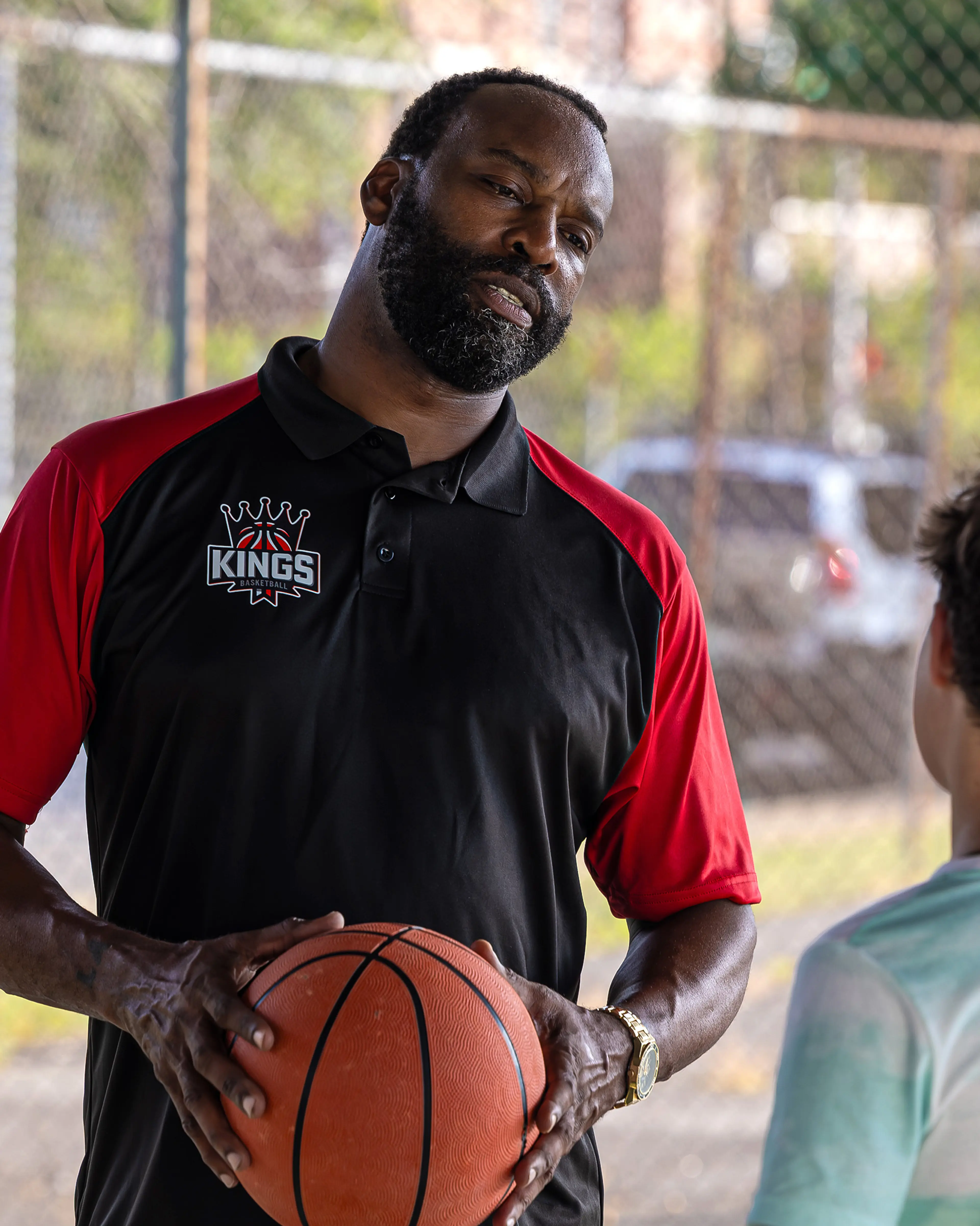 Baron Davis holds a basketball beside Dylan Friedman on an outdoor court in Last Shot.