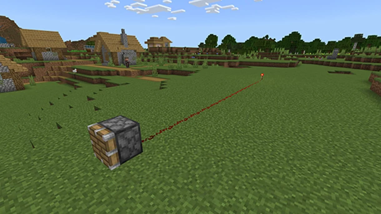 A simple Minecraft redstone line connecting a redstone torch to a piston.