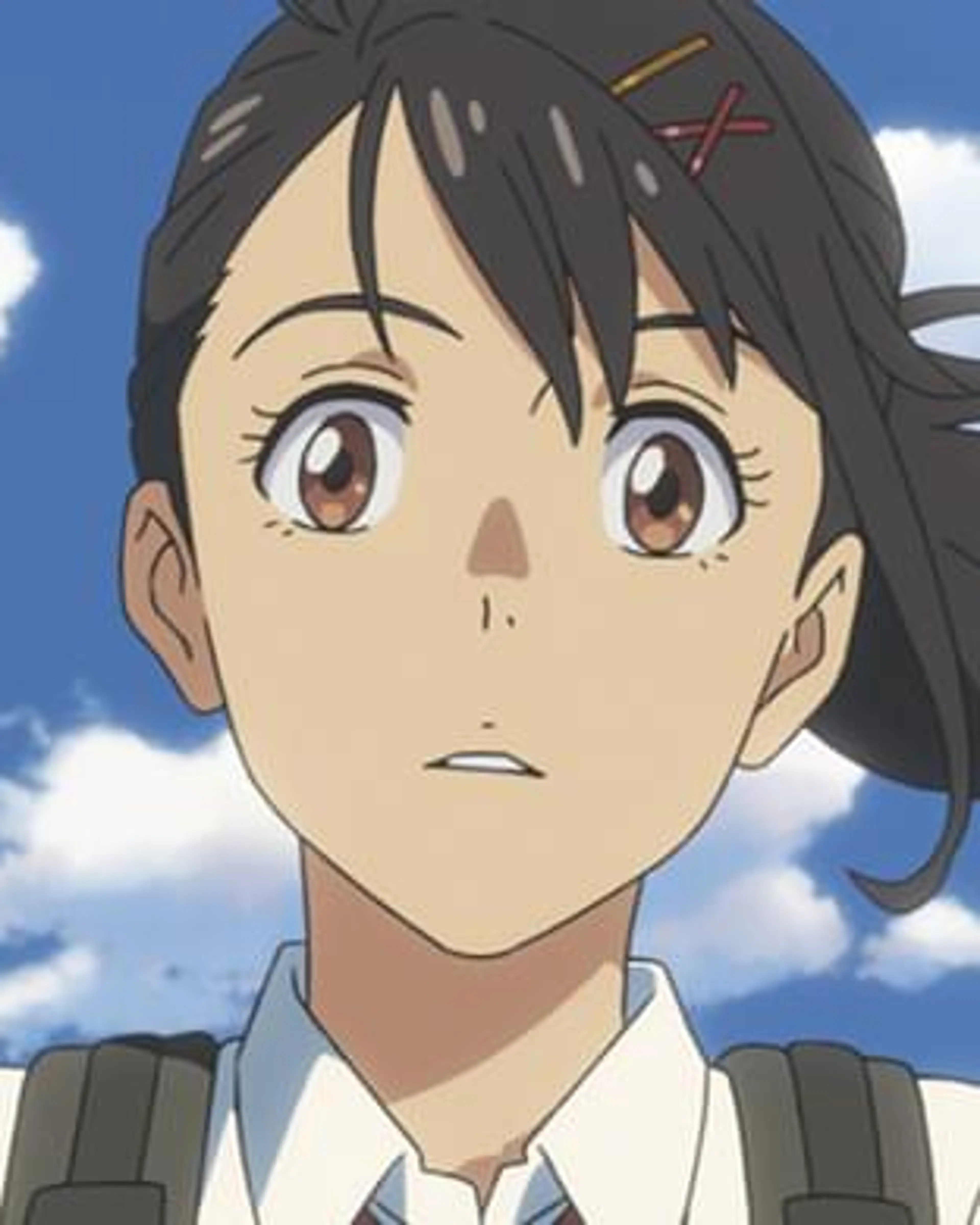 Suzume Iwato looks up beneath a blue sky.