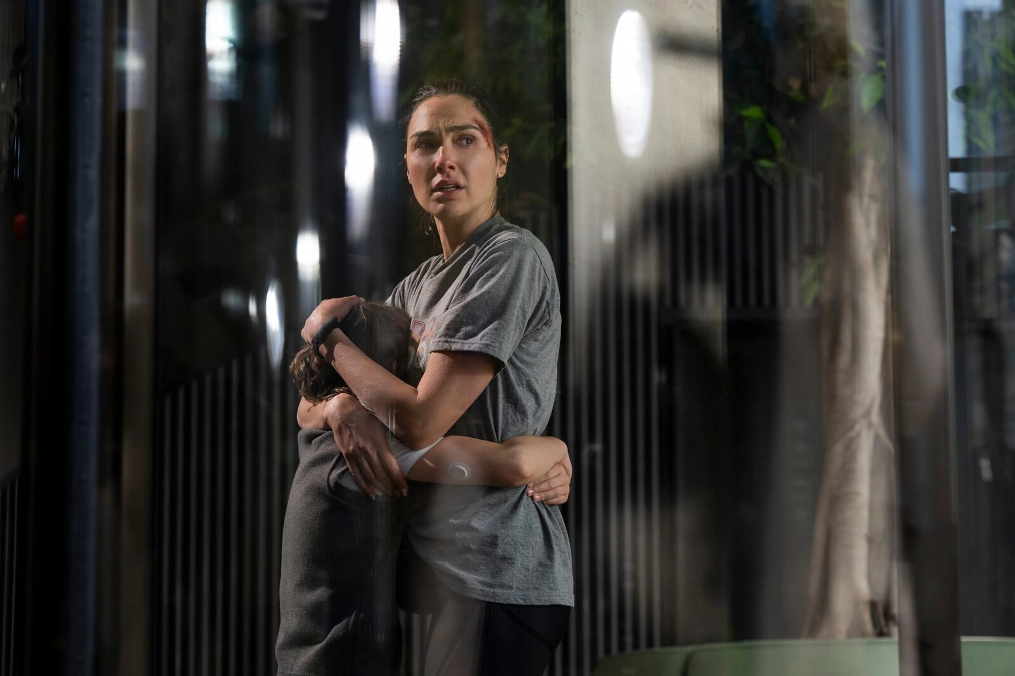Gal Gadot as Maia Marten embraces her son Noah in The Runner.