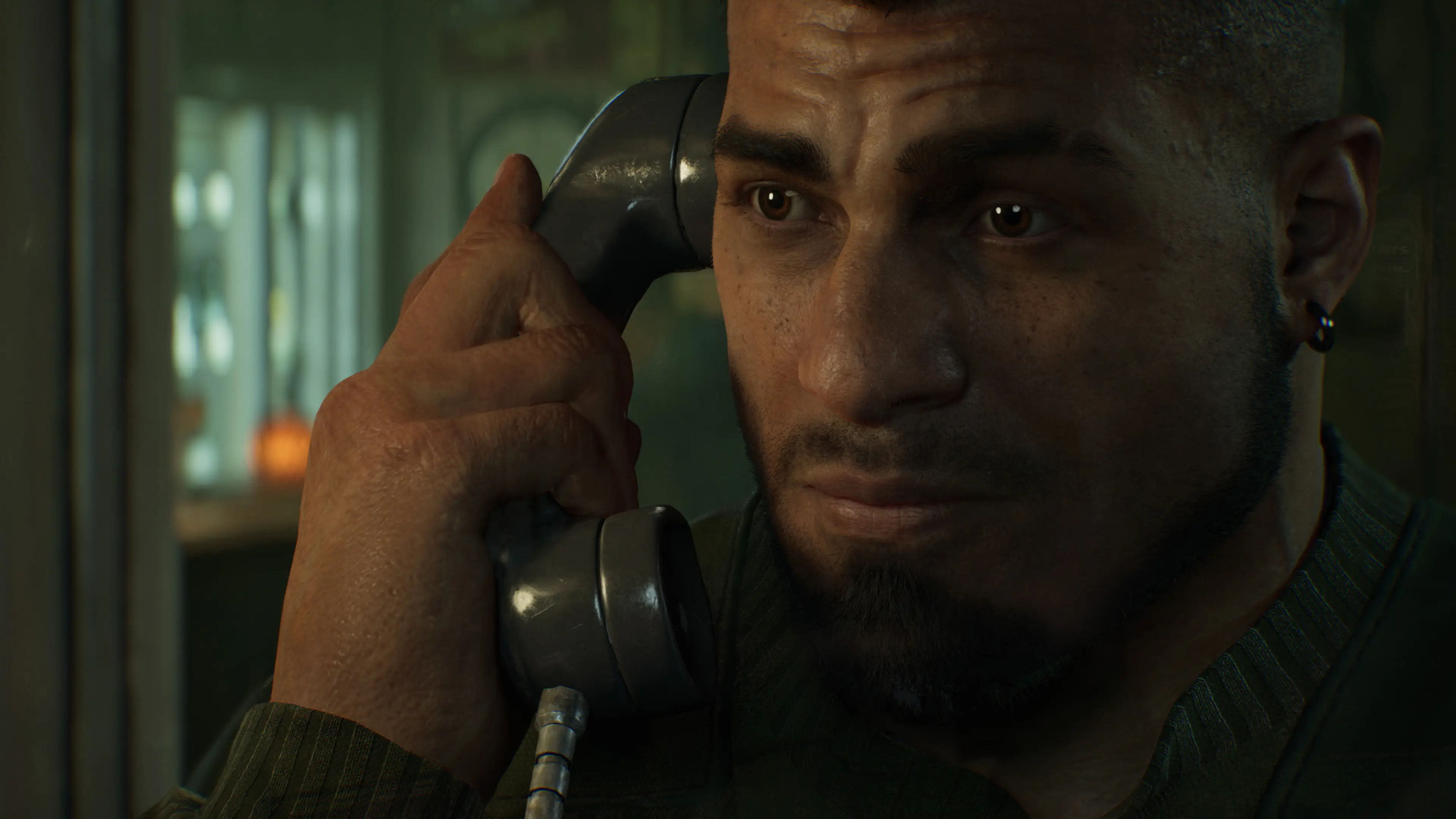 Dom speaks into a public telephone receiver with a worried expression.