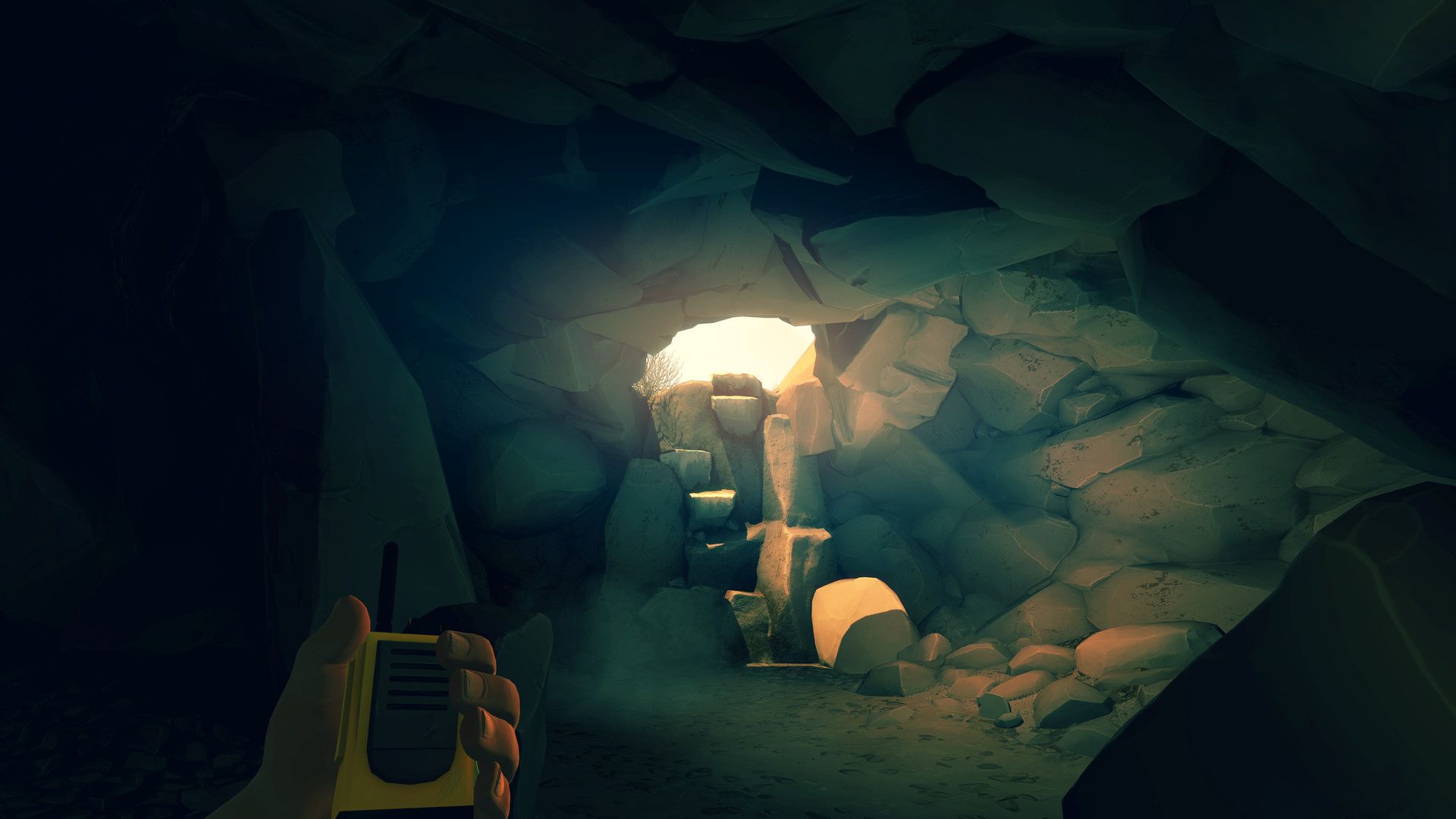 A dim cave passage seen while holding a radio.