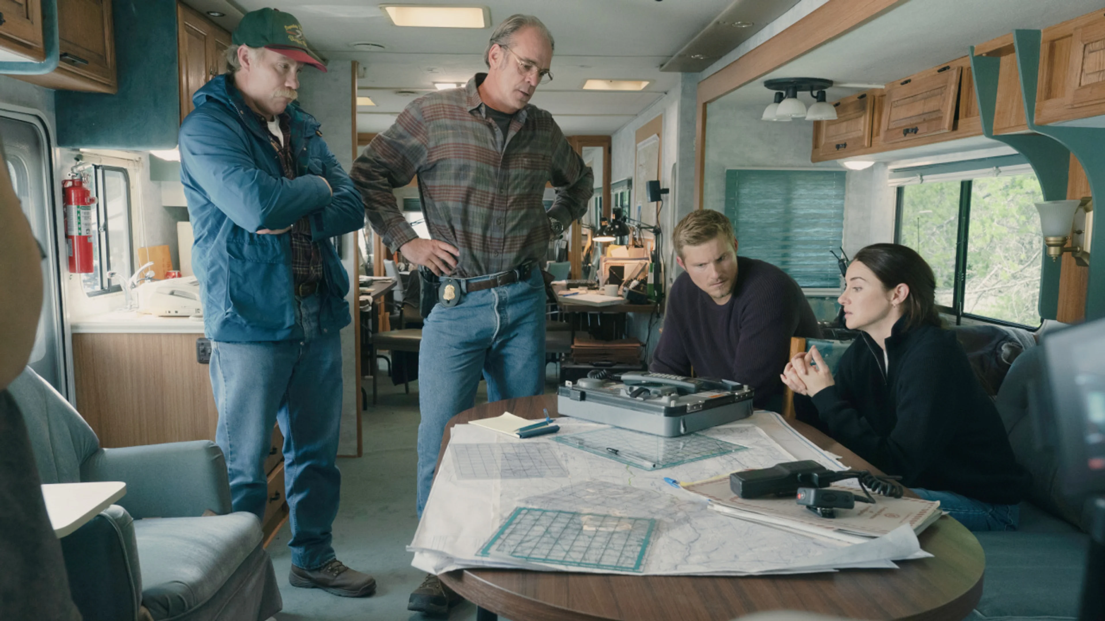 Shailene Woodley sits with other FBI agents around a table in UNABOMBER.