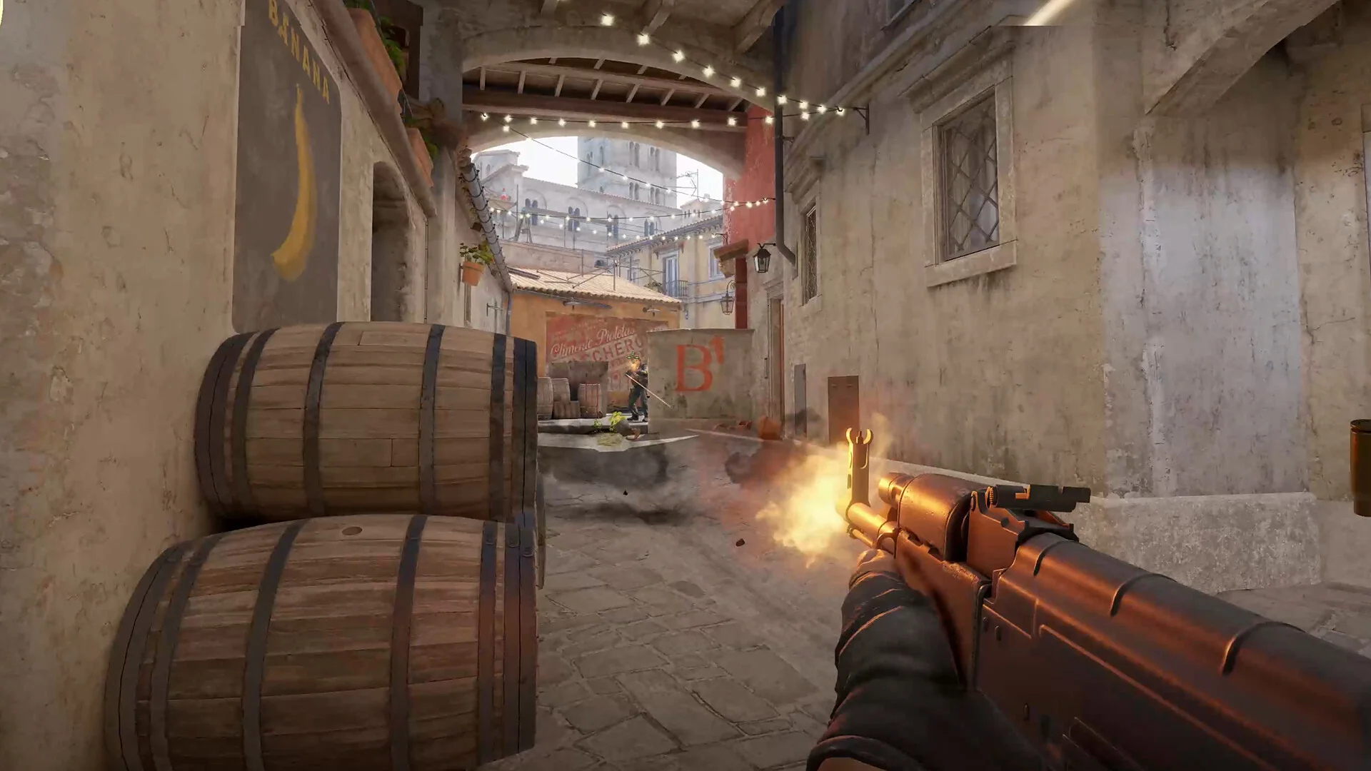 A Counter-Strike 2 player fires a rifle toward an opponent near a bombsite.