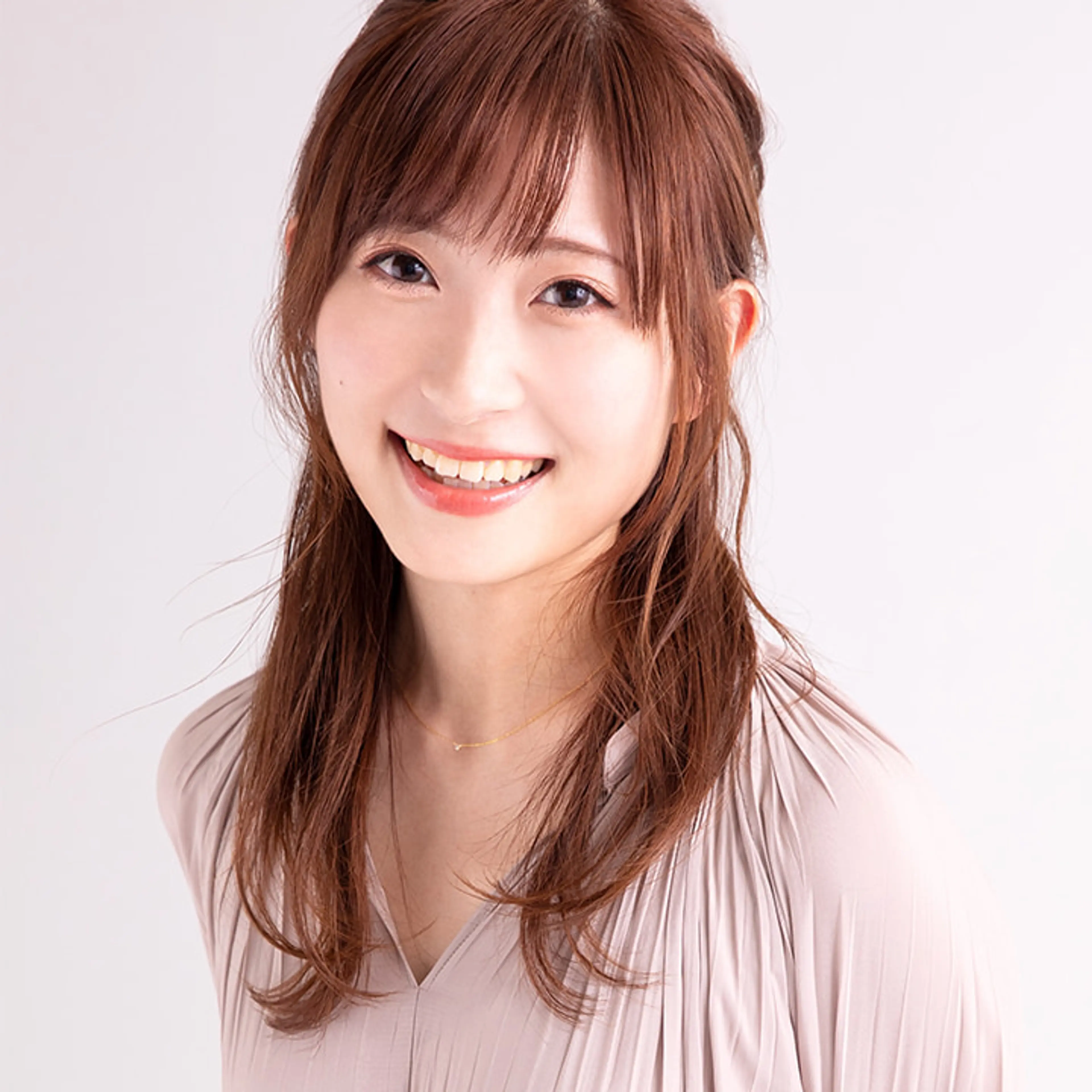 Haruka Shiraishi smiling in a pale blouse.