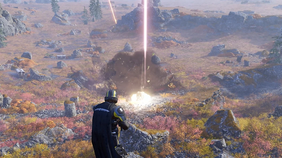 A Helldiver watches an Orbital Stratagem strike a distant target on an open battlefield.