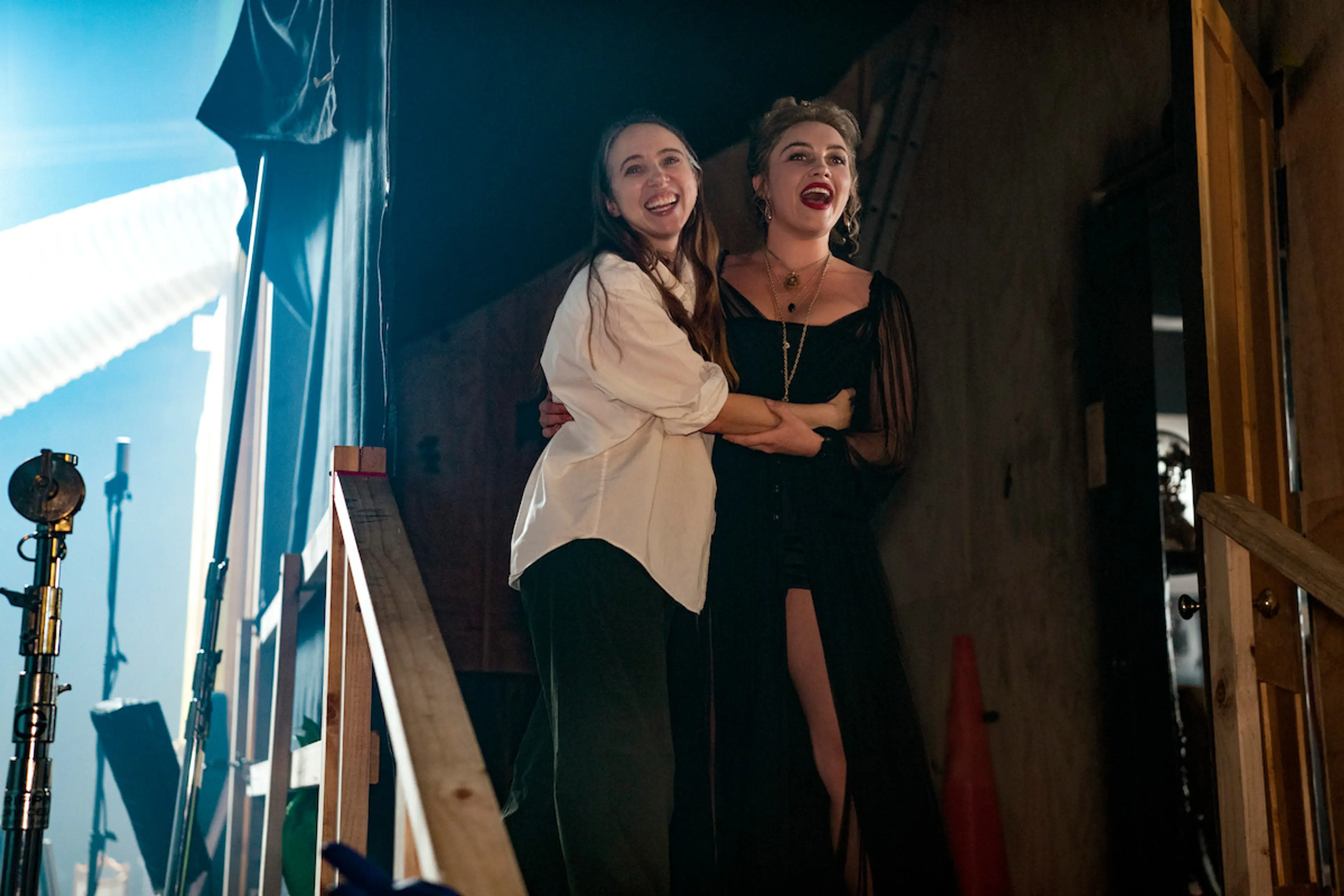 Zoe Kazan and Florence Pugh smile together on the East of Eden set.