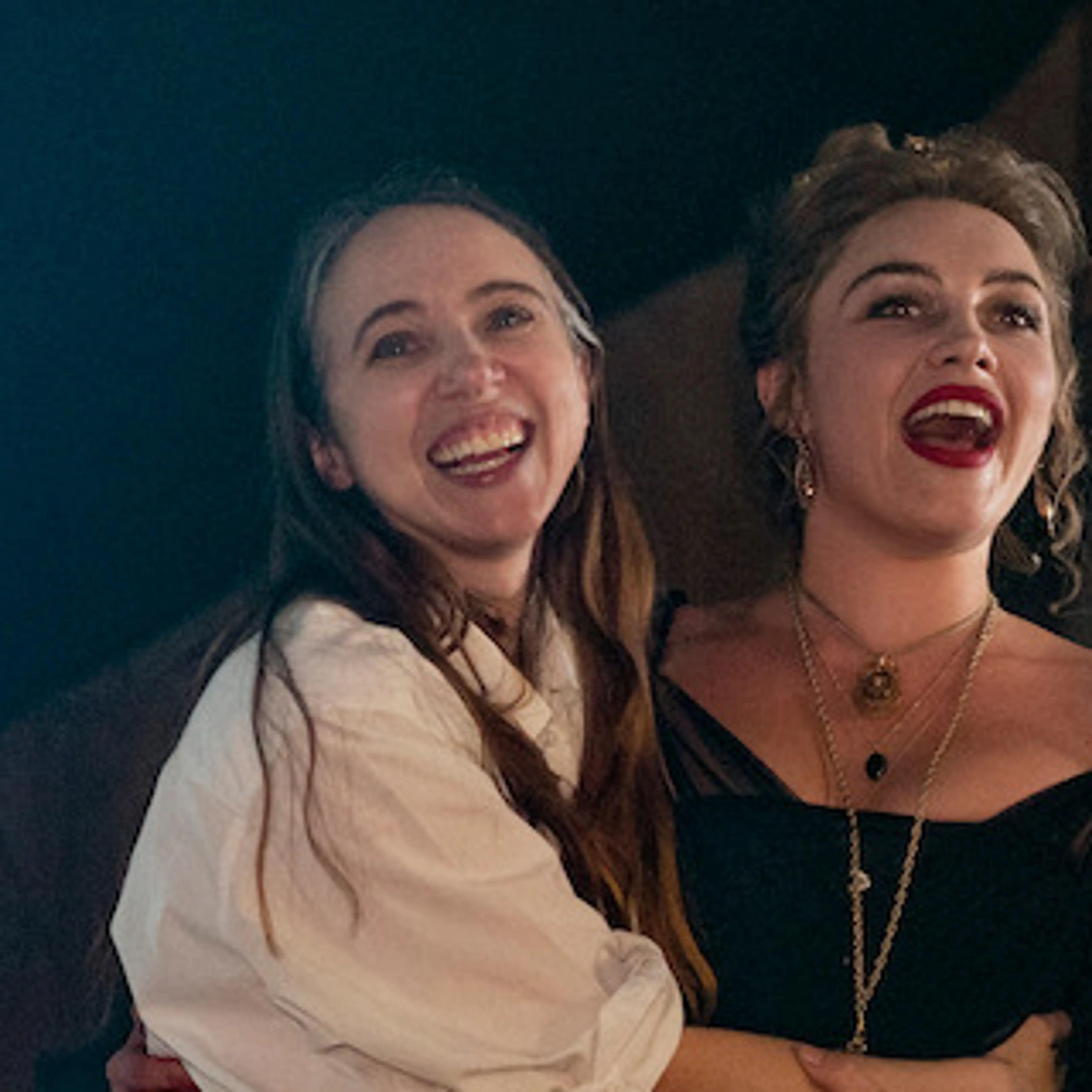 Zoe Kazan smiles beside Florence Pugh on the set of East of Eden.