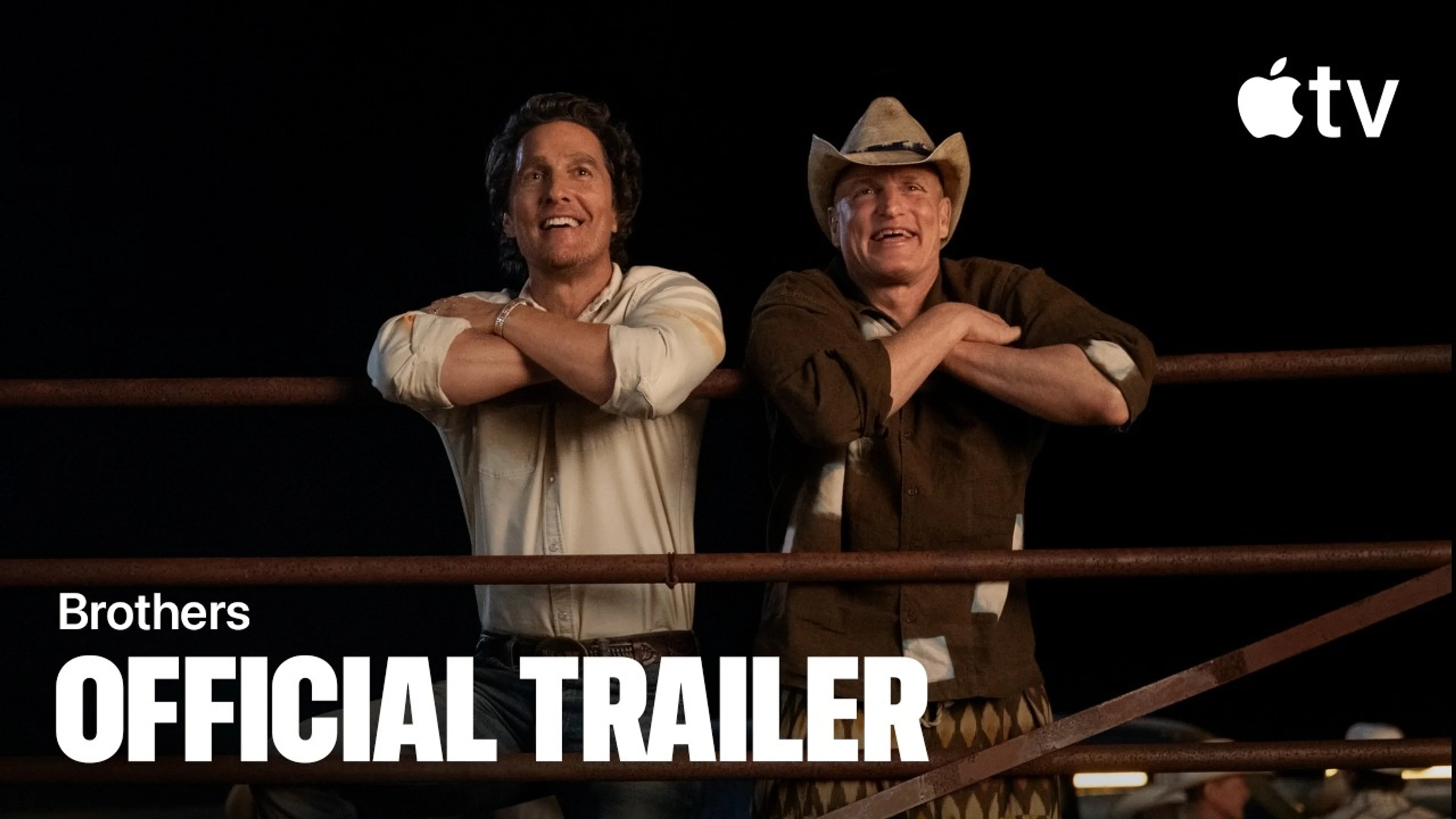 Matthew McConaughey and Woody Harrelson lean on a fence in the official Brothers trailer image.
