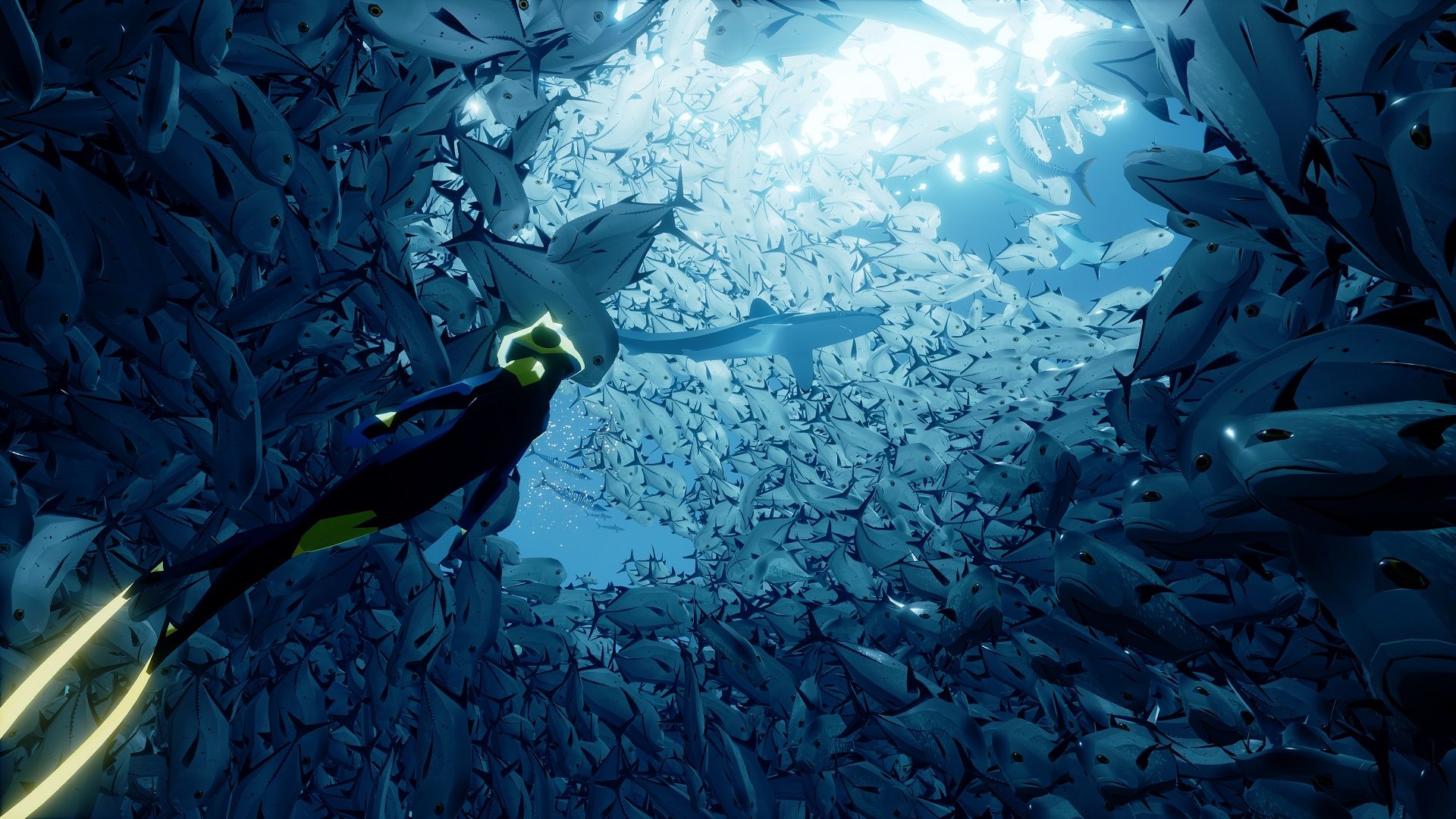 A diver swims through a dense school of fish in ABZÛ.