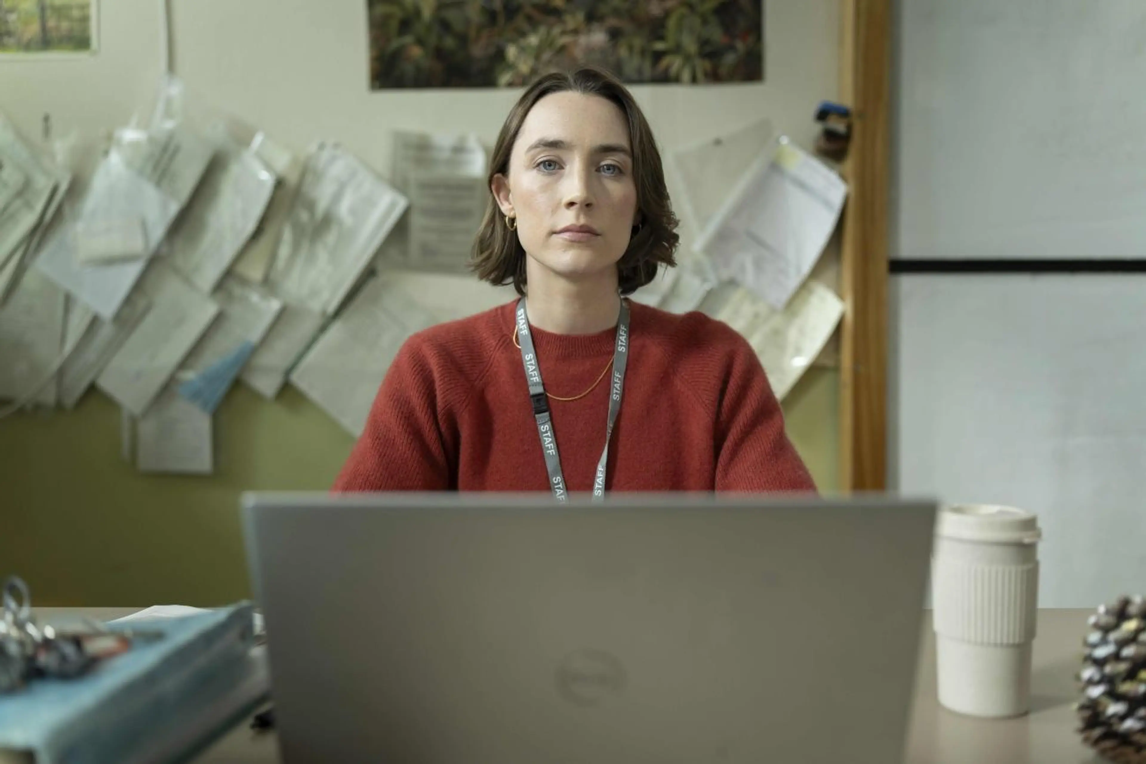 Saoirse Ronan sits at a desk as teacher Maria in Bad Apples.