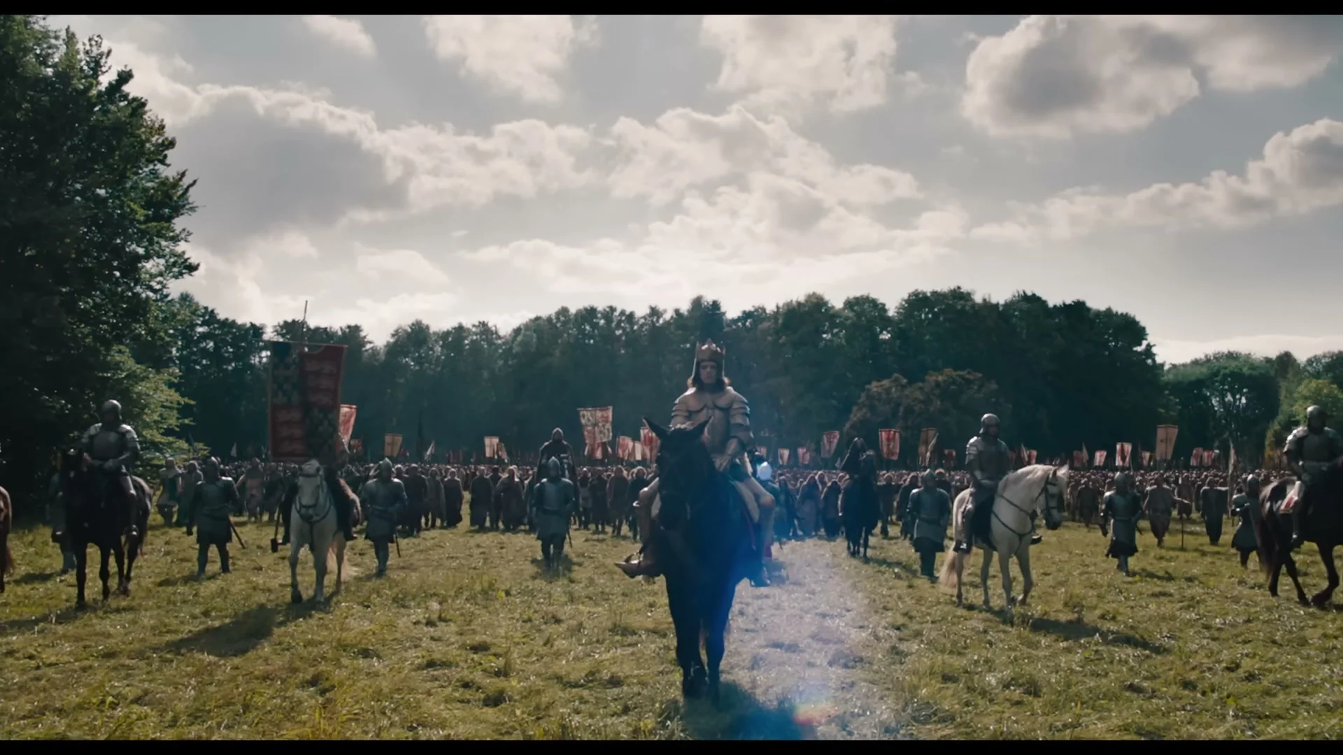 King Richard II in armor stands with royal forces facing the rebels in The Uprising.