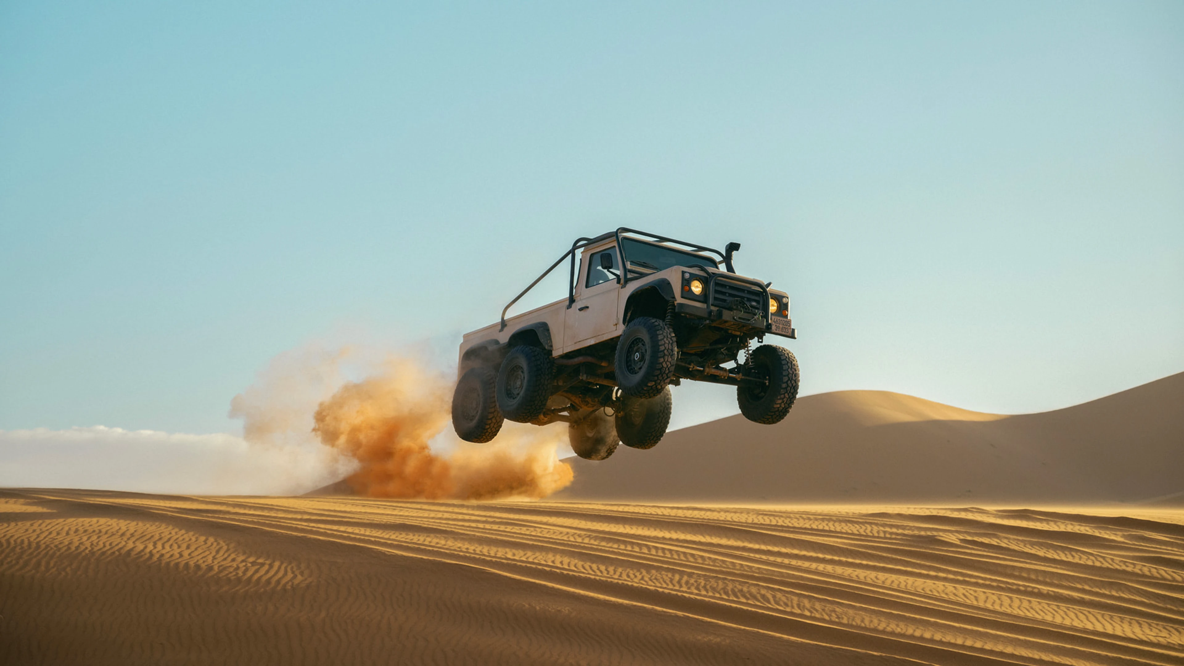 An off-road truck jumps above the desert in Matchbox The Movie.