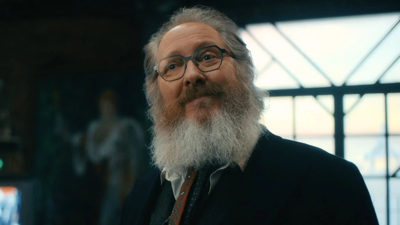 James Spader as Ultron, wearing glasses and a dark suit in VisionQuest.