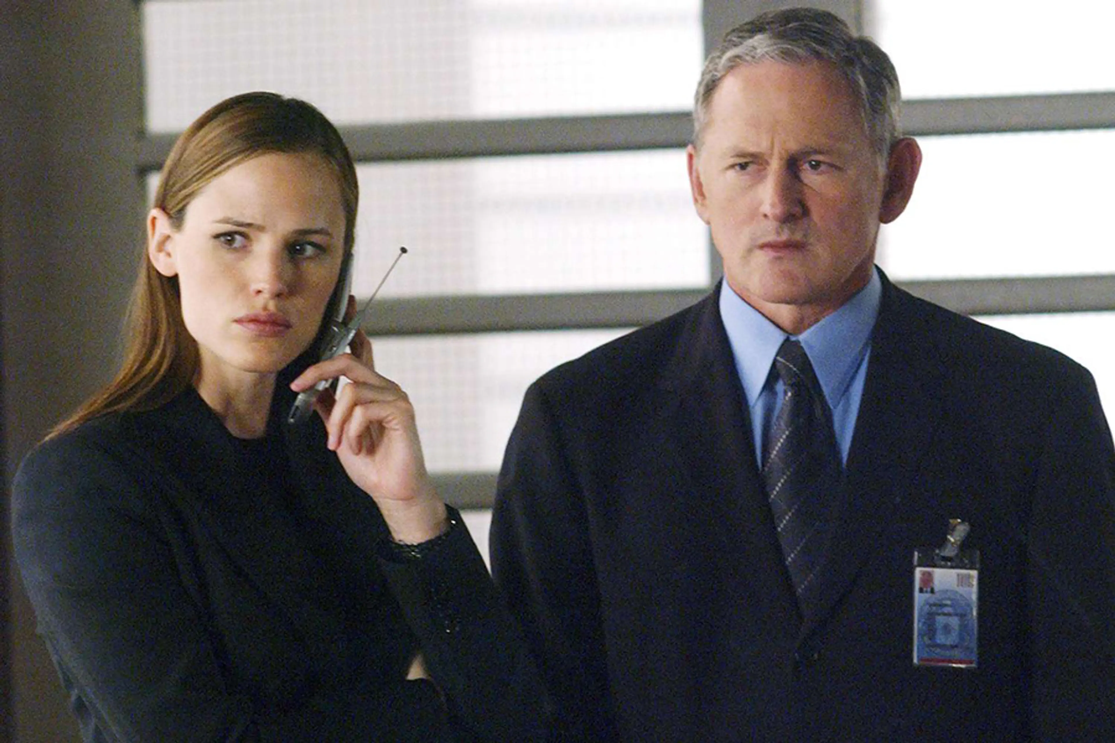 Jennifer Garner and Victor Garber stand together in an Alias scene.