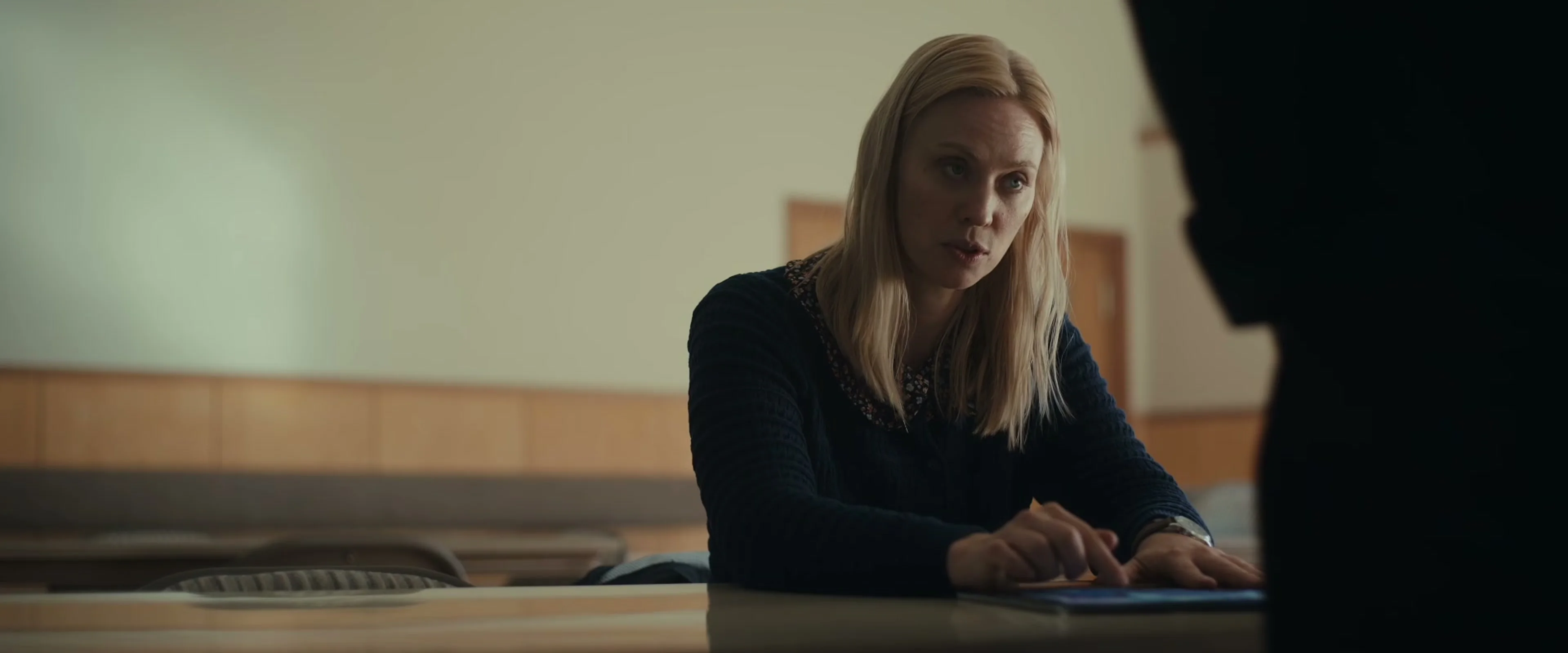 Deborah Ann Woll sits across a table from another person in The Cycle trailer.