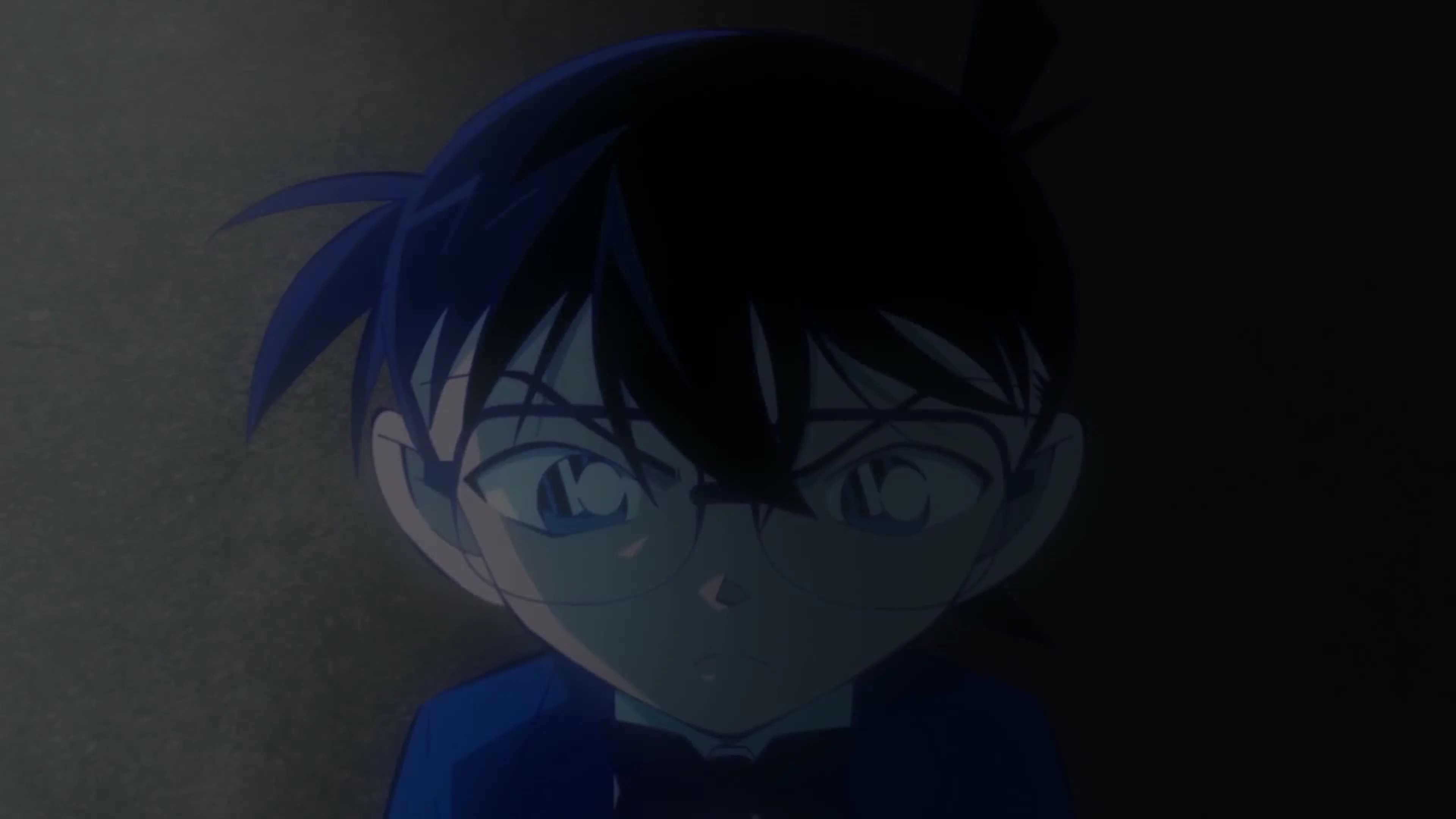Conan Edogawa appears in a dark blue-lit shot from the anniversary trailer.