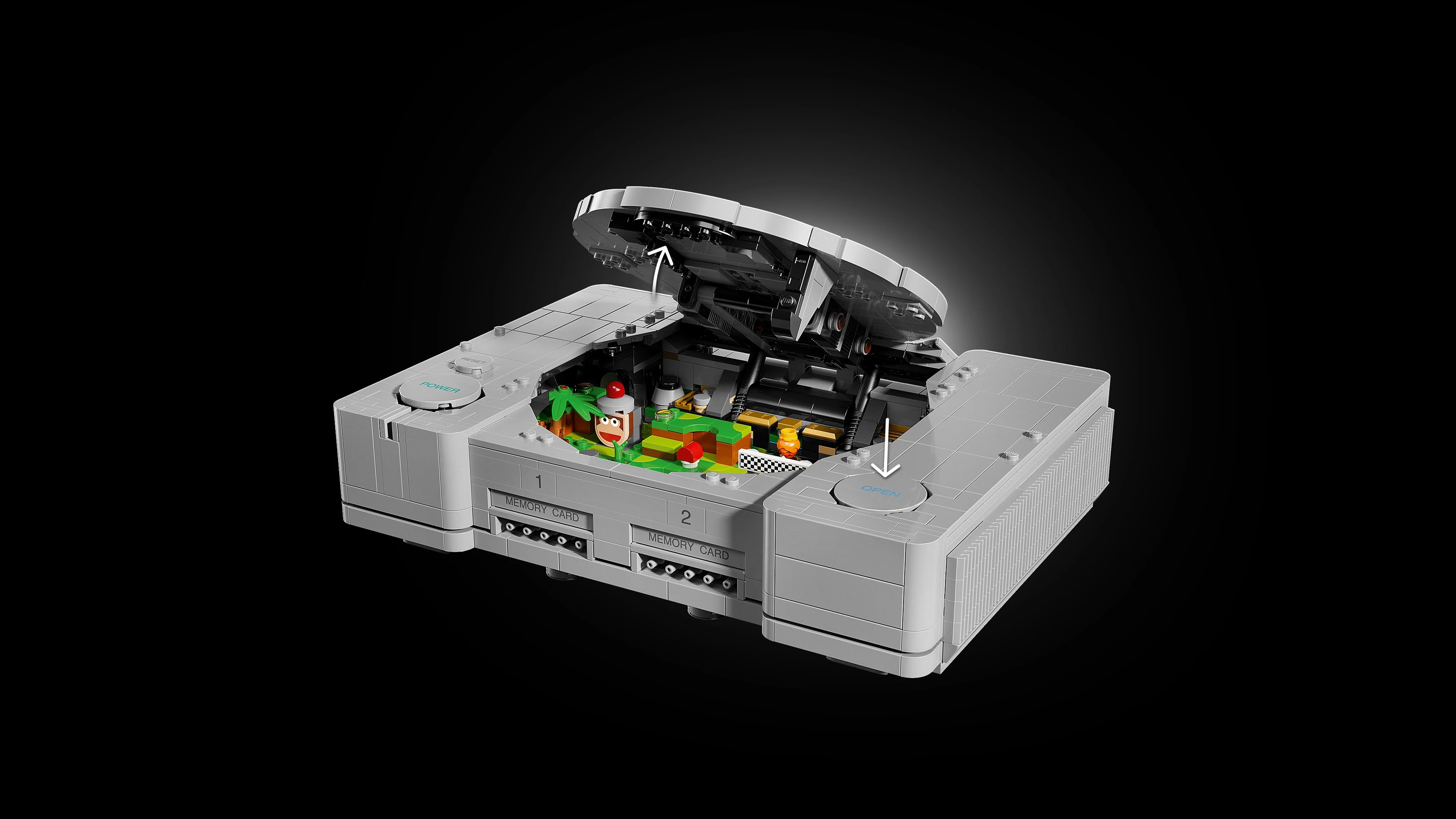 A LEGO replica of the original PlayStation console and controller rests on a blue display surface.
