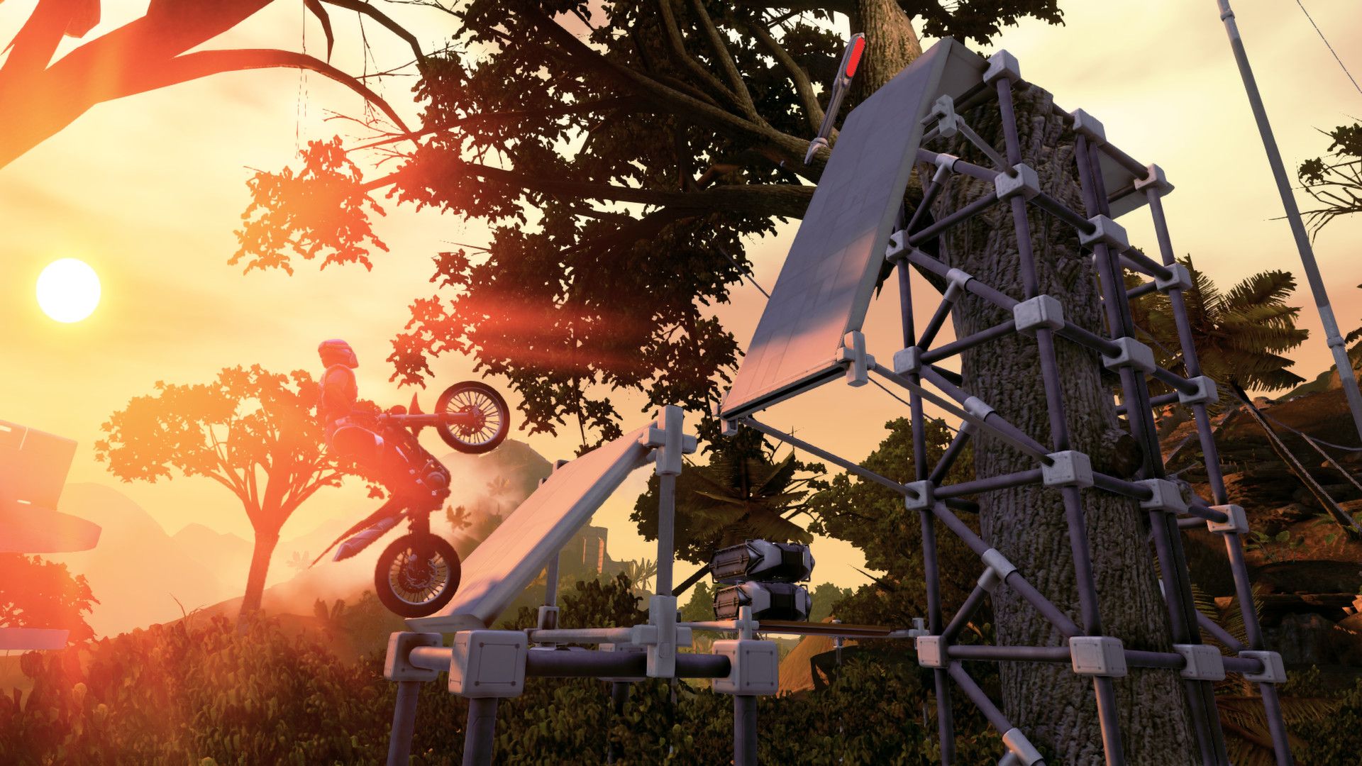 A rider climbs a steep wooden obstacle at sunset.