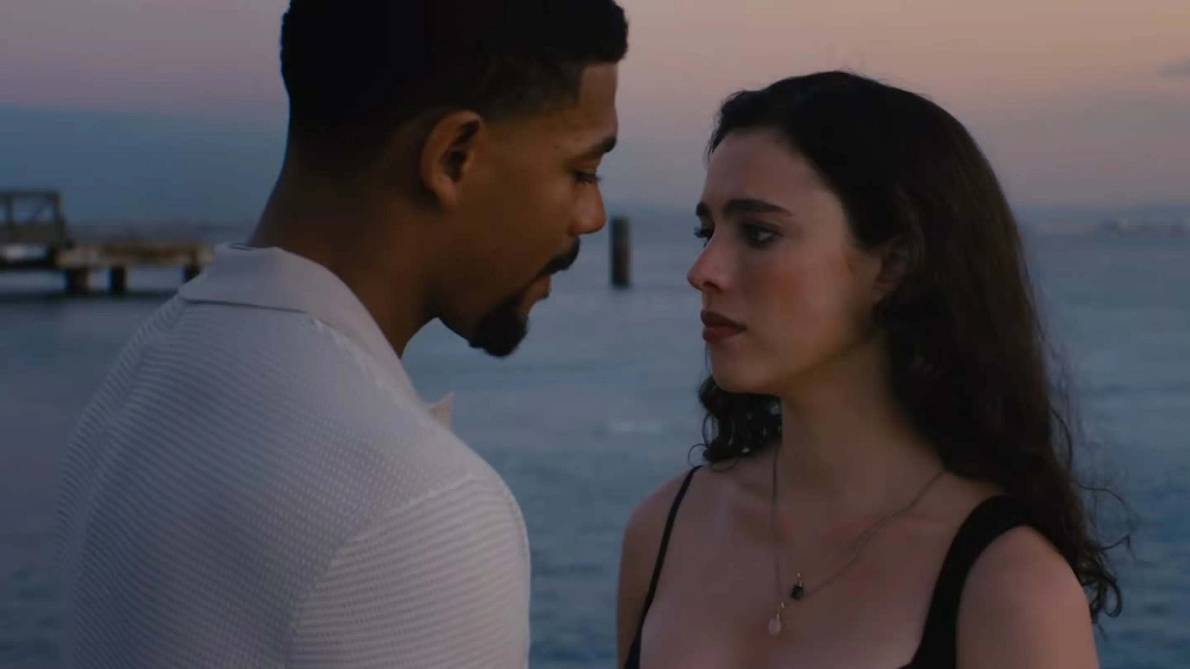 Maya looks at a man during a quiet conversation beside the water in Love of Your Life.