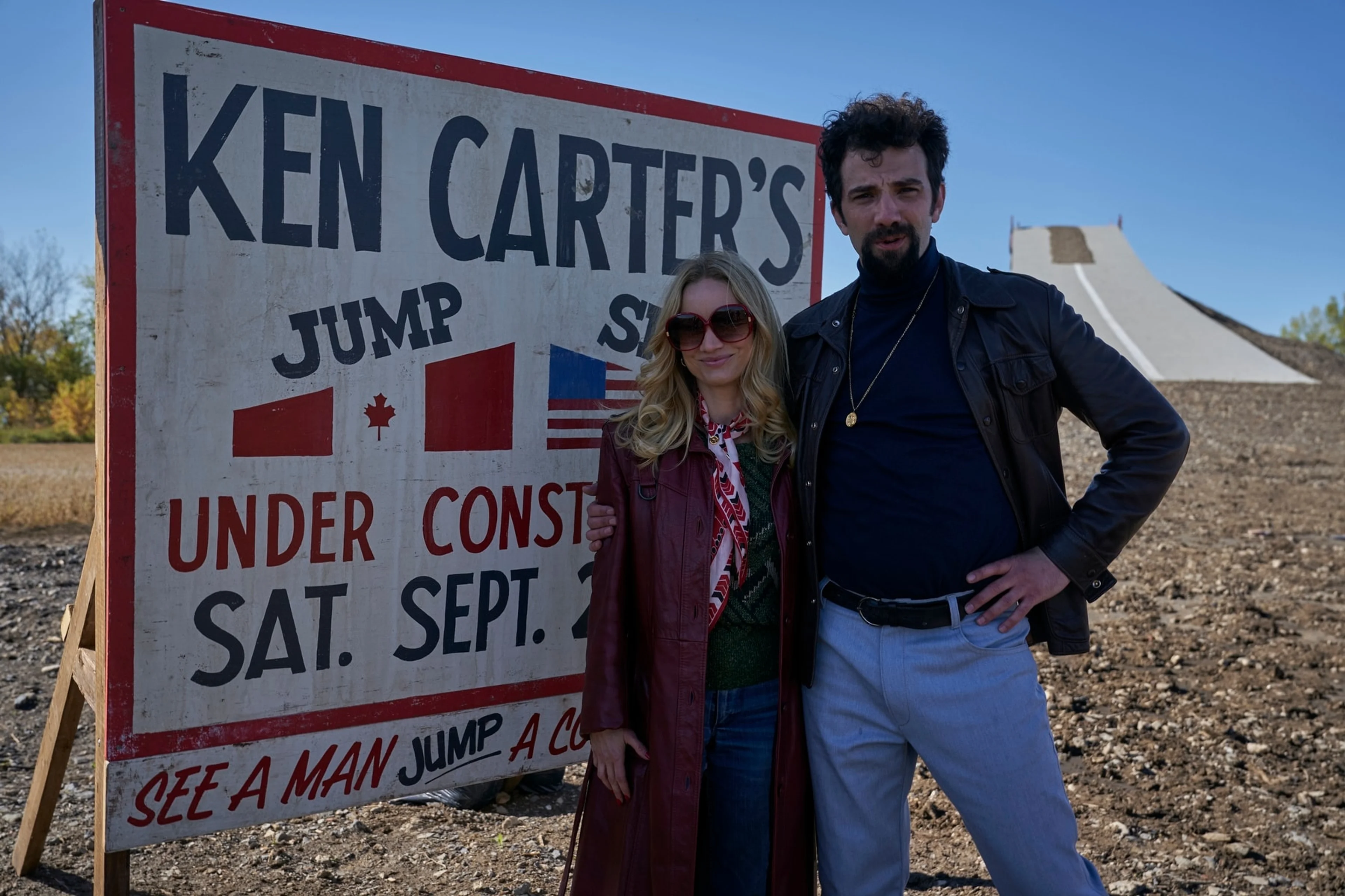 Characters stand in front of a sign advertising Ken Carter’s jump.
