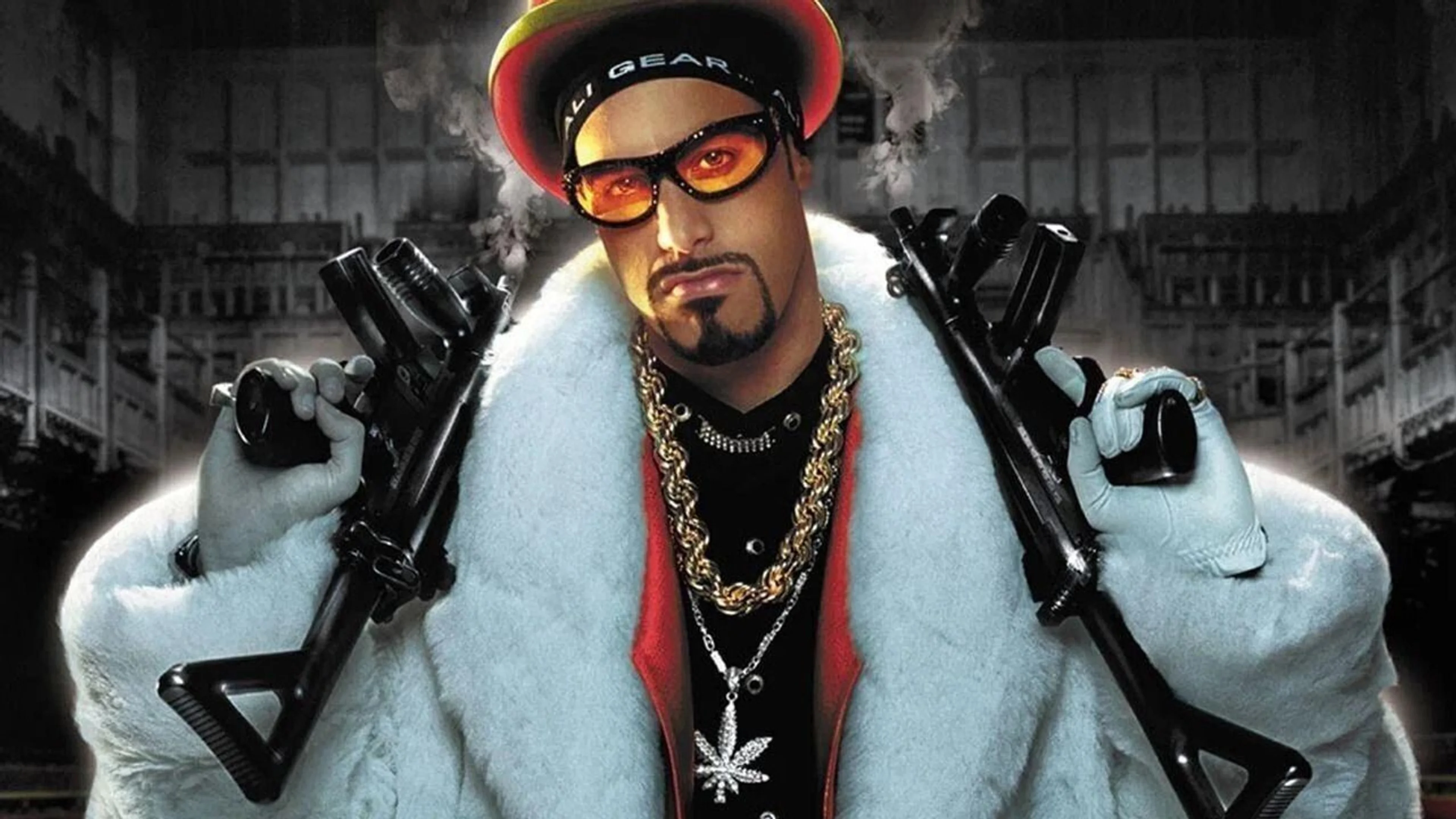 Ali G stands in a white fur coat with sunglasses and gold chains in promotional artwork for Ali G: Who Iz I?.