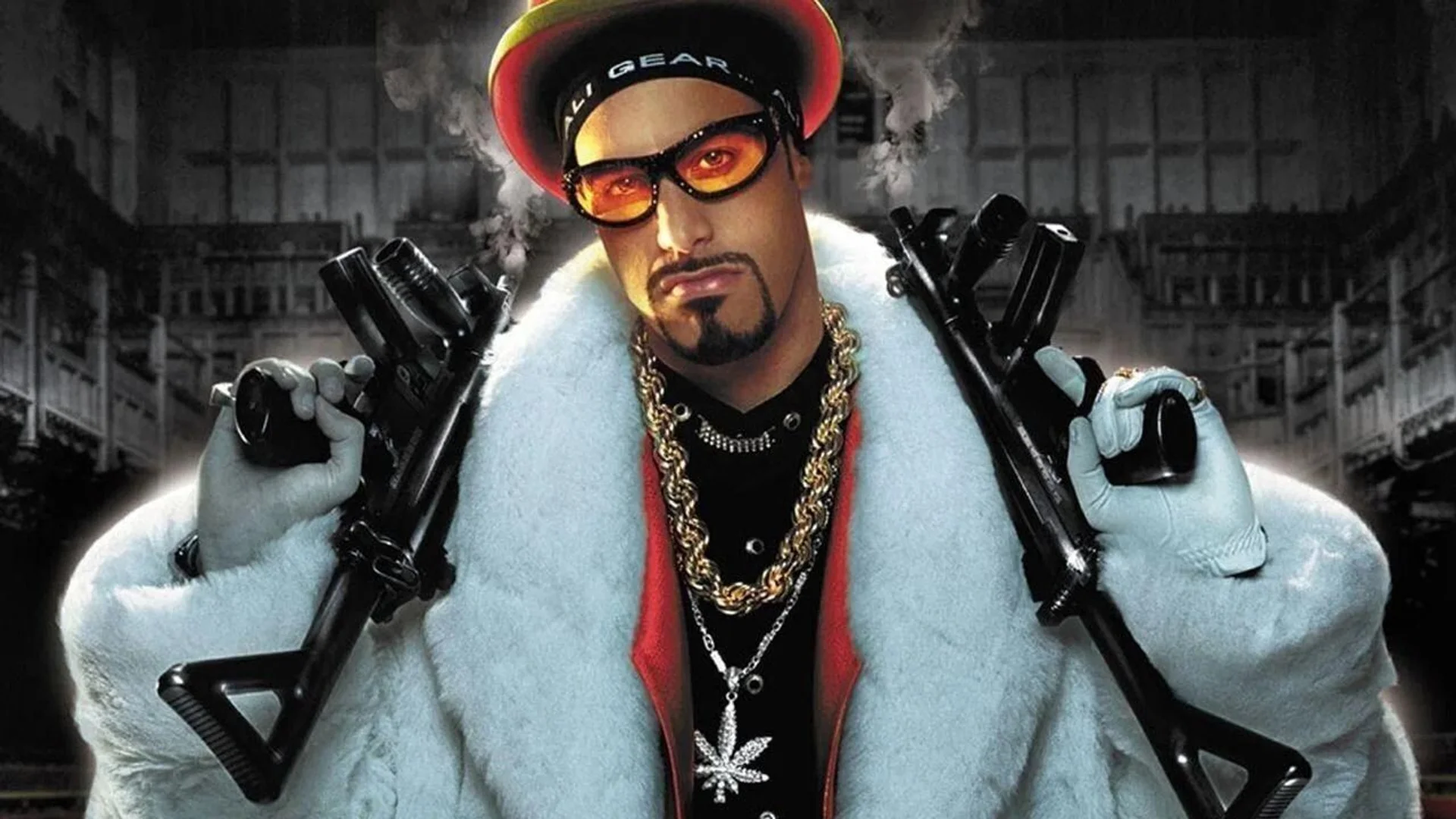 Ali G stands in a white fur coat with sunglasses and gold chains in promotional artwork for Ali G: Who Iz I?.