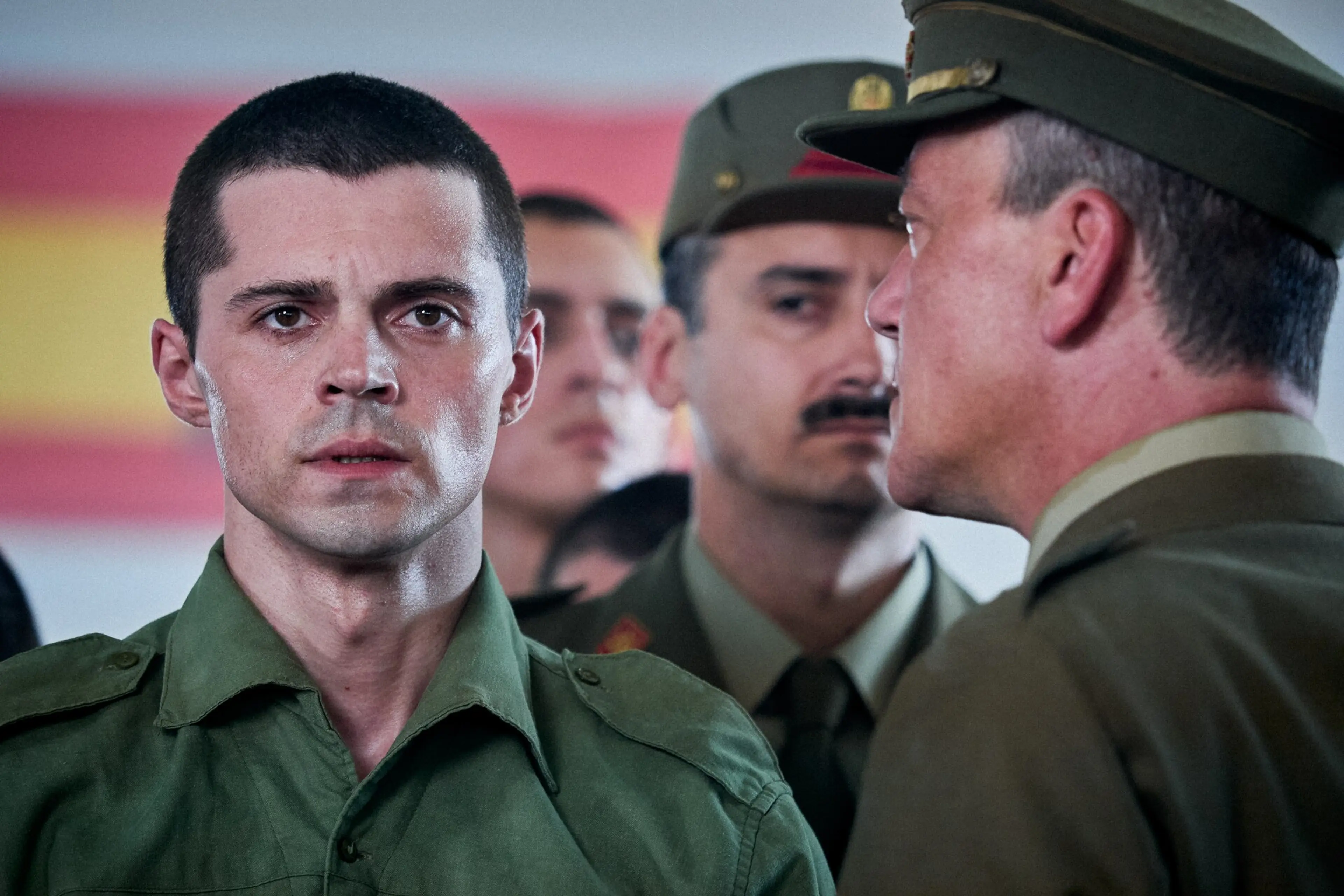 The younger Raphael wears a green military uniform in A Day Like No Other.
