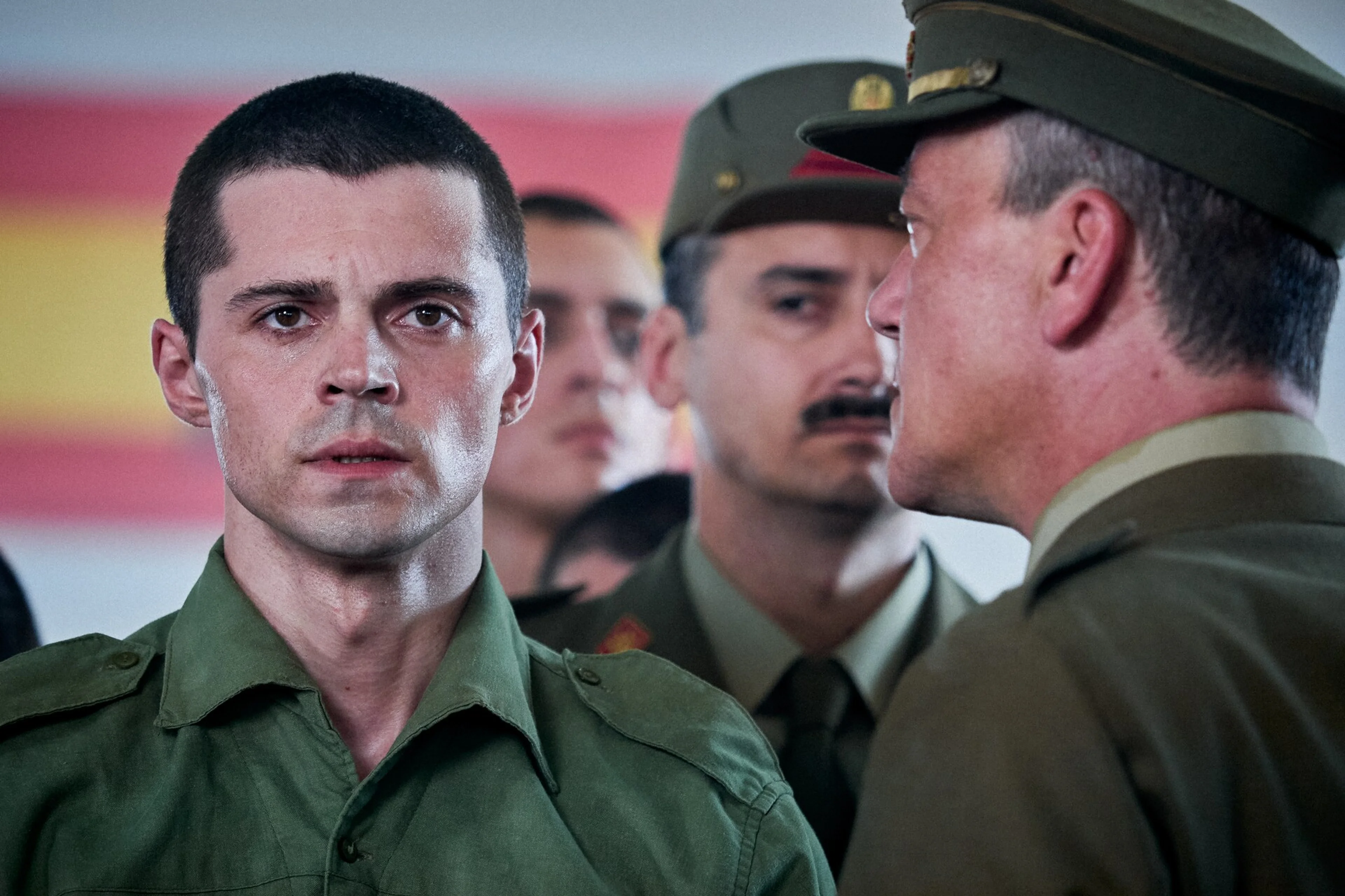 The younger Raphael wears a green military uniform in A Day Like No Other.