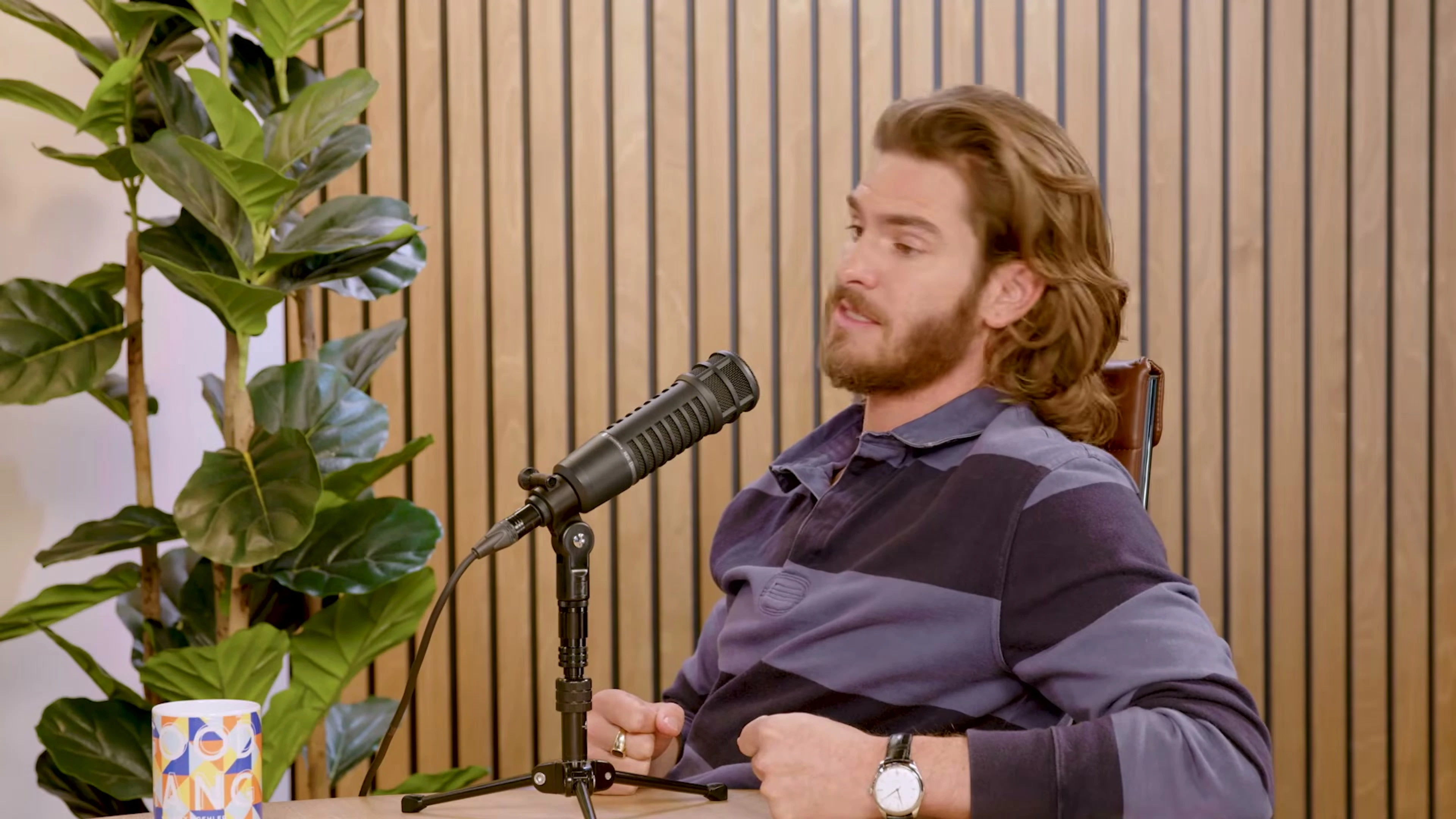Andrew Garfield speaks into a microphone during his Good Hang interview.