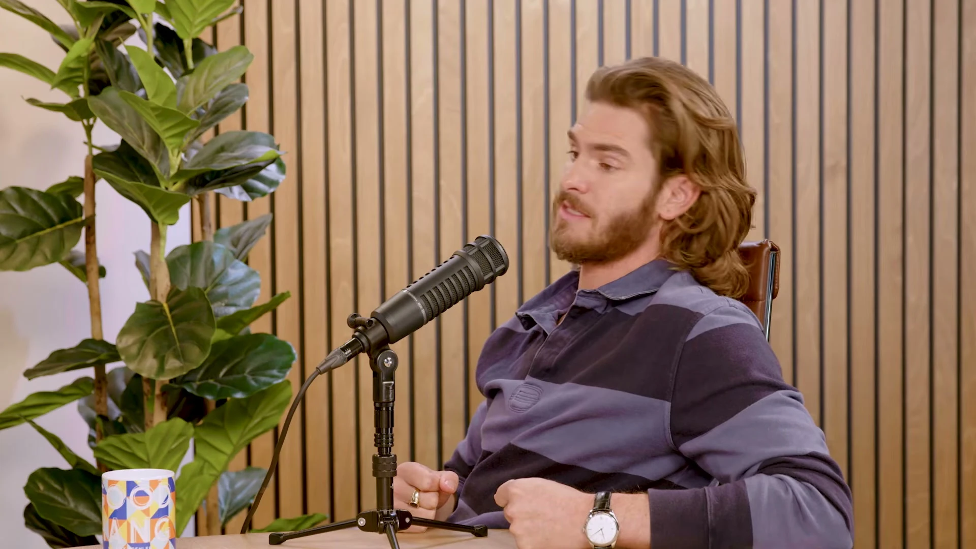 Andrew Garfield speaks into a microphone during his Good Hang interview.