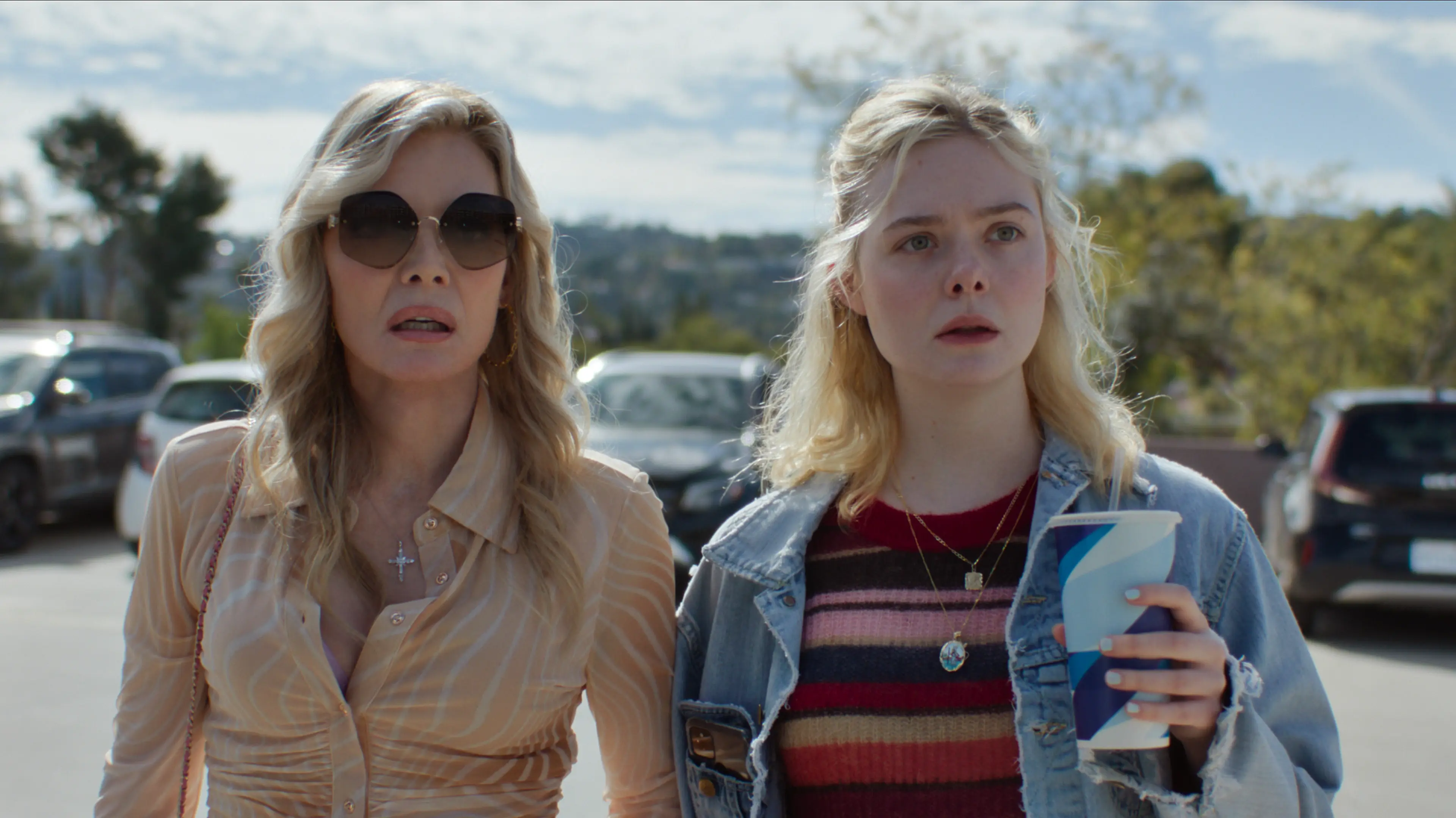 Michelle Pfeiffer as Shyanne and Elle Fanning as Margo stand together outdoors.