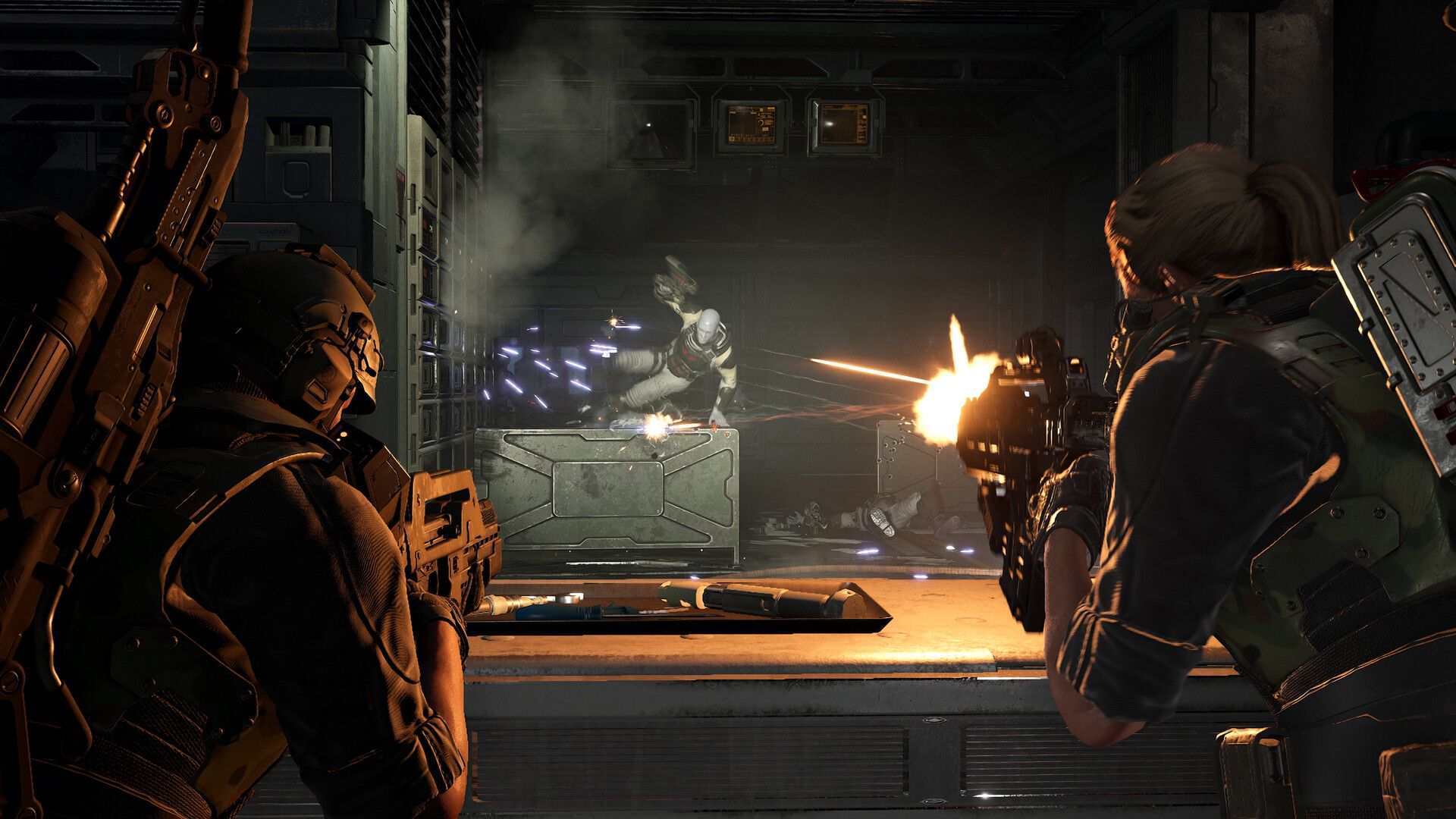 Marines fire at enemies across an industrial room in Aliens: Fireteam Elite 2.