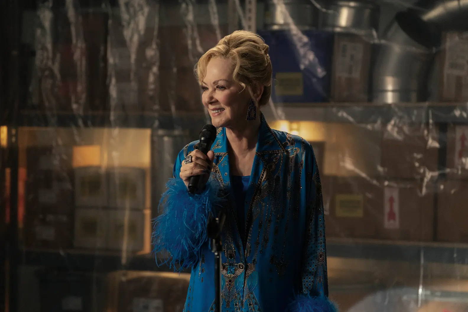 Jean Smart as Deborah Vance holds a microphone in Hacks.