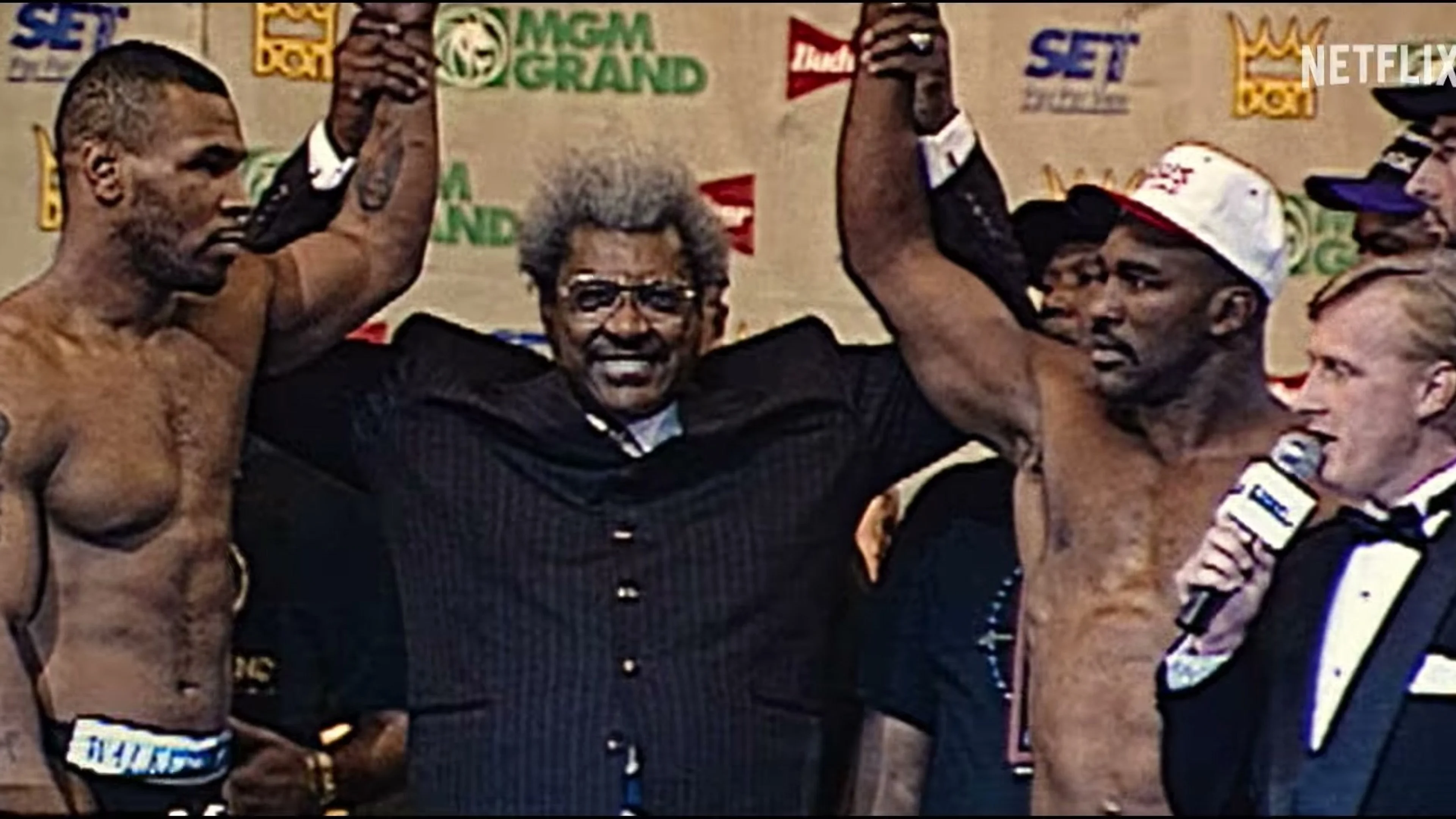 A young Mike Tyson celebrates a championship victory in archival footage.