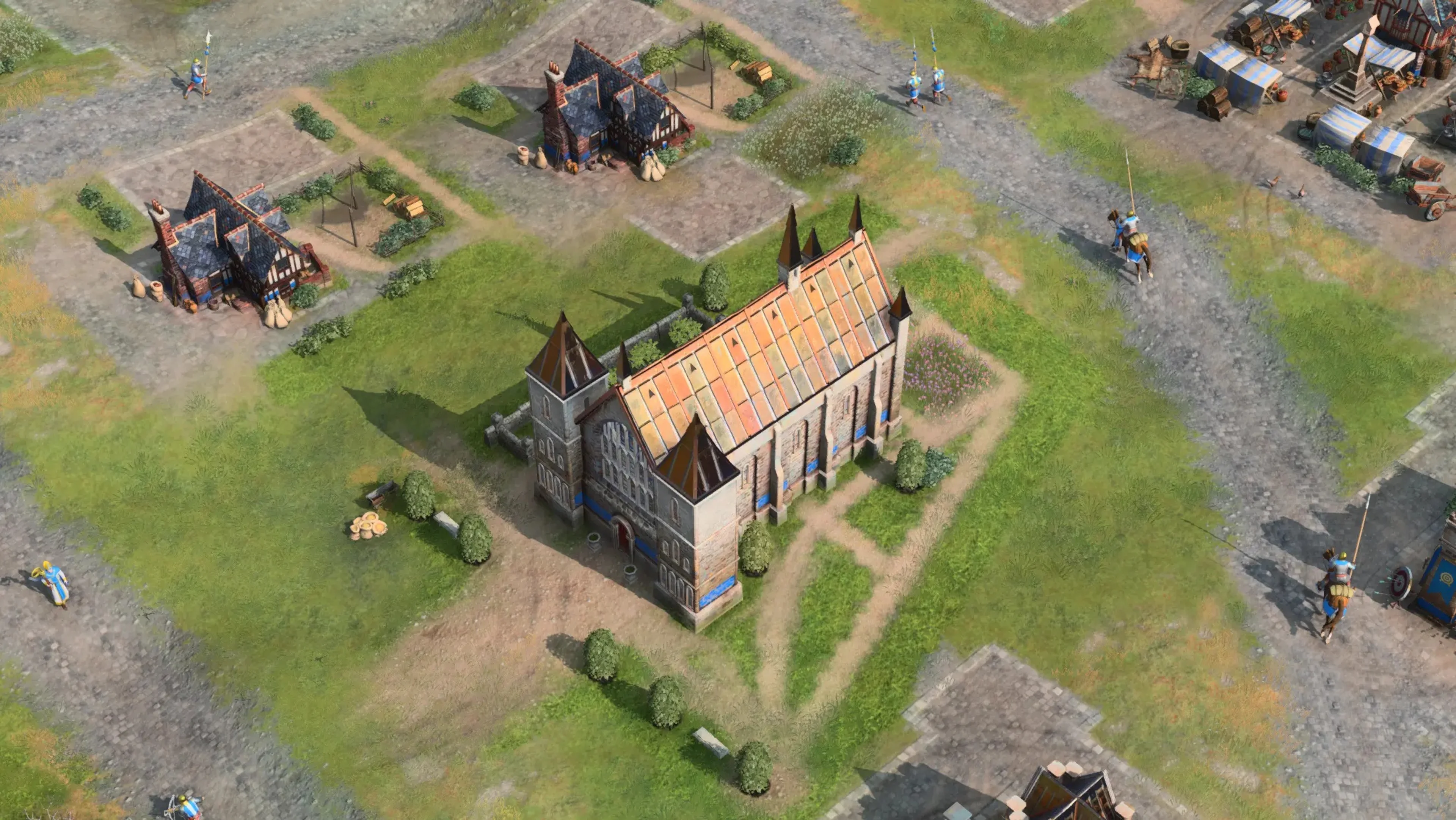Council Hall is the long English landmark with the orange roof and round corner towers. Completing it advances the English to Feudal Age; select the finished building to train your first Longbowmen.