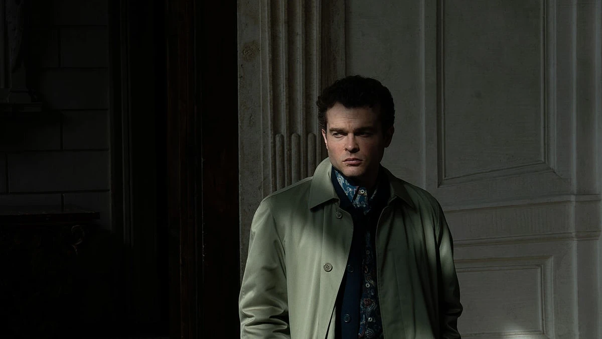 Alden Ehrenreich as Edward stands in a doorway in A Talent for Murder.
