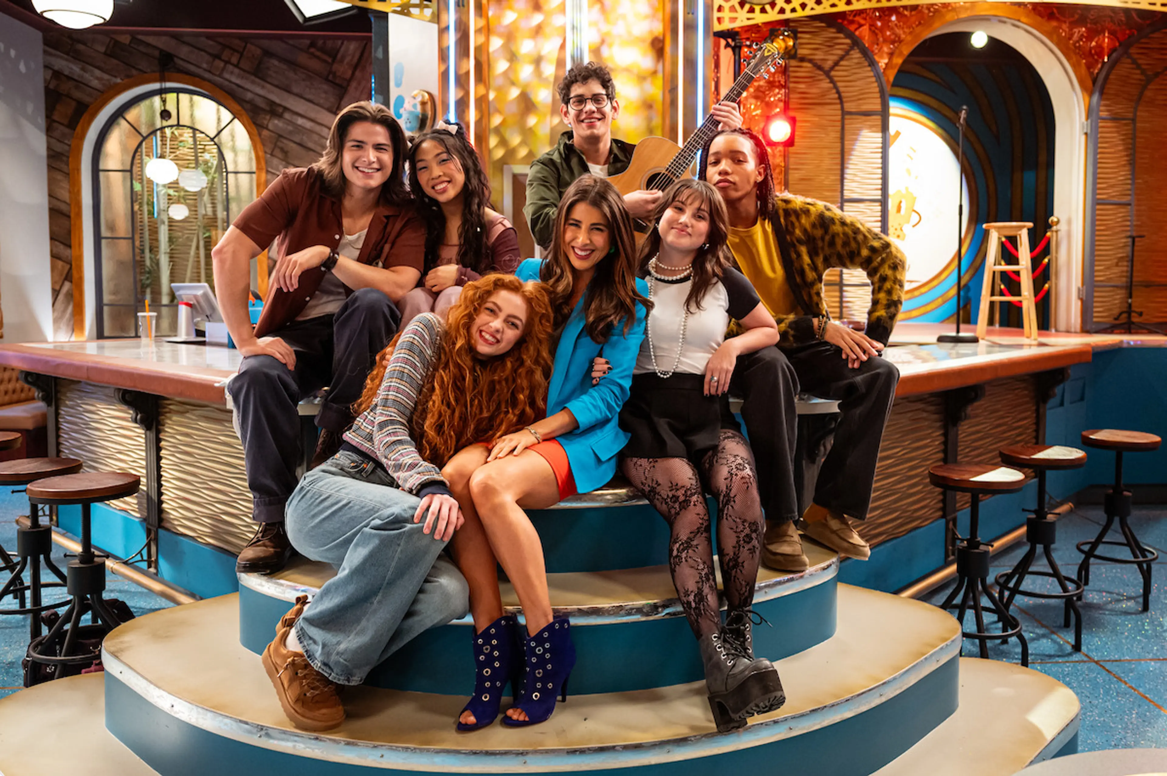 Daniella Monet as Trina Vega stands with the new Hollywood Arts student cast.