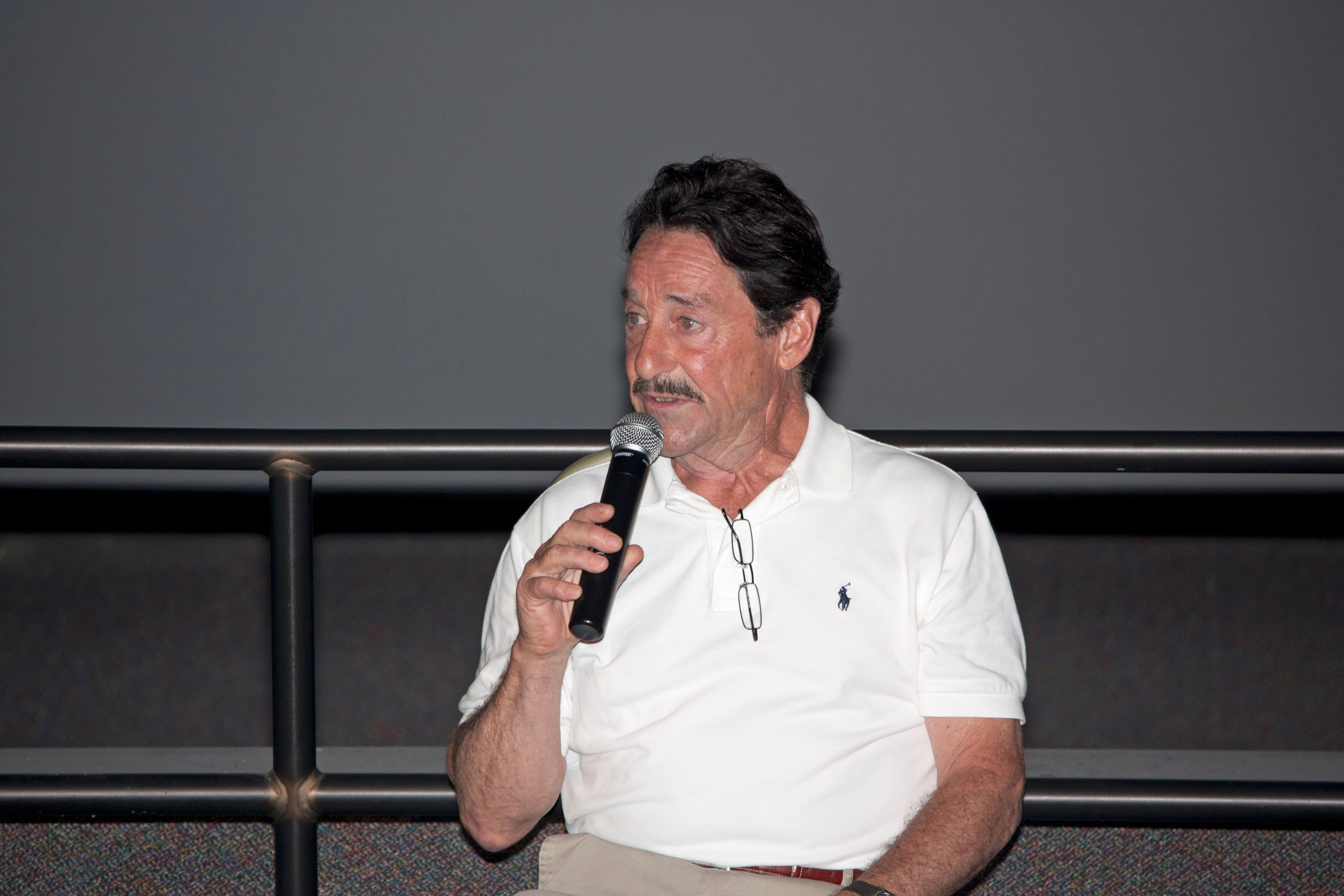 Peter Cullen speaks into a microphone at Kennedy Space Center in July 2011.