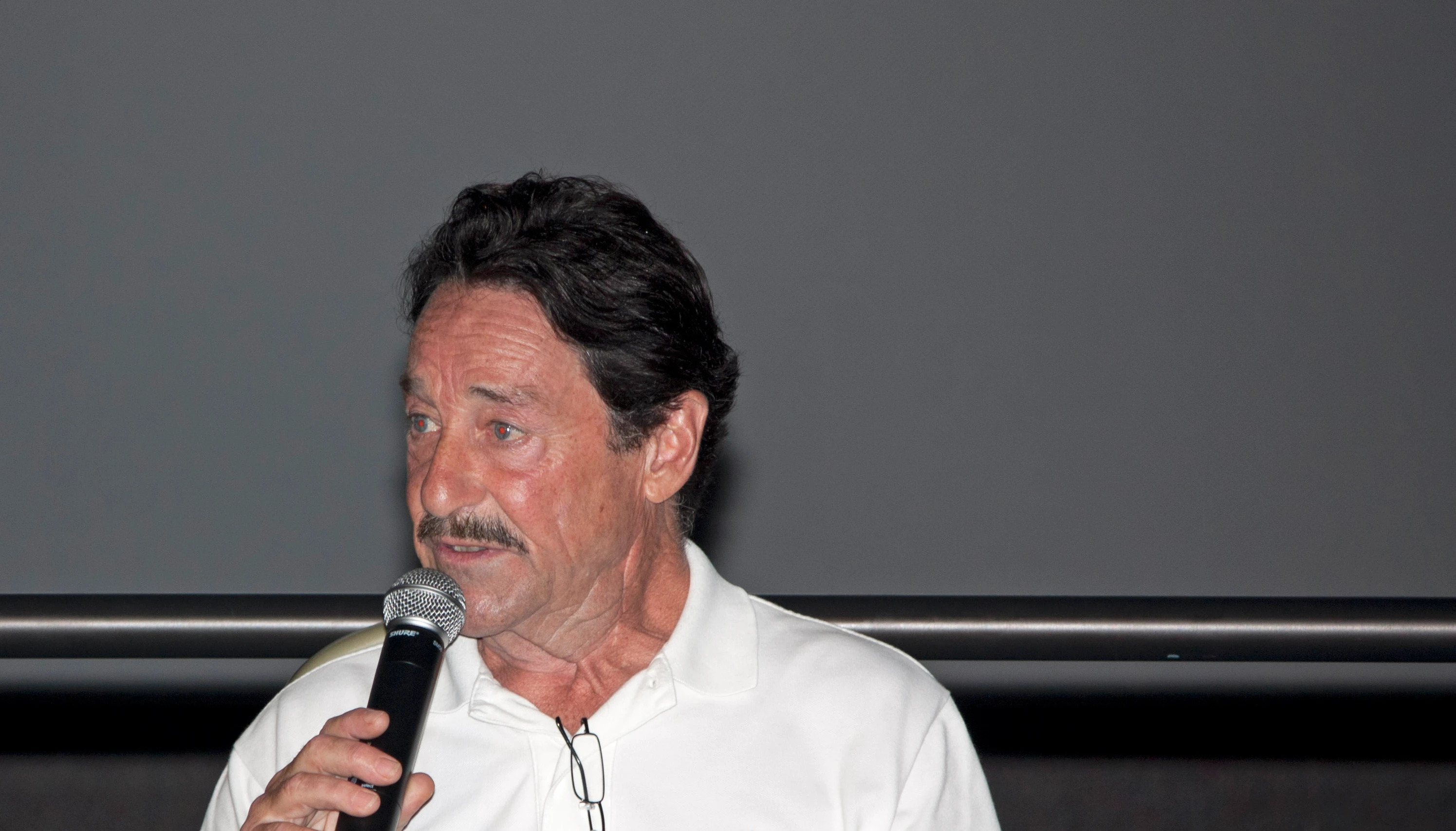 Peter Cullen speaks into a microphone at Kennedy Space Center in July 2011.