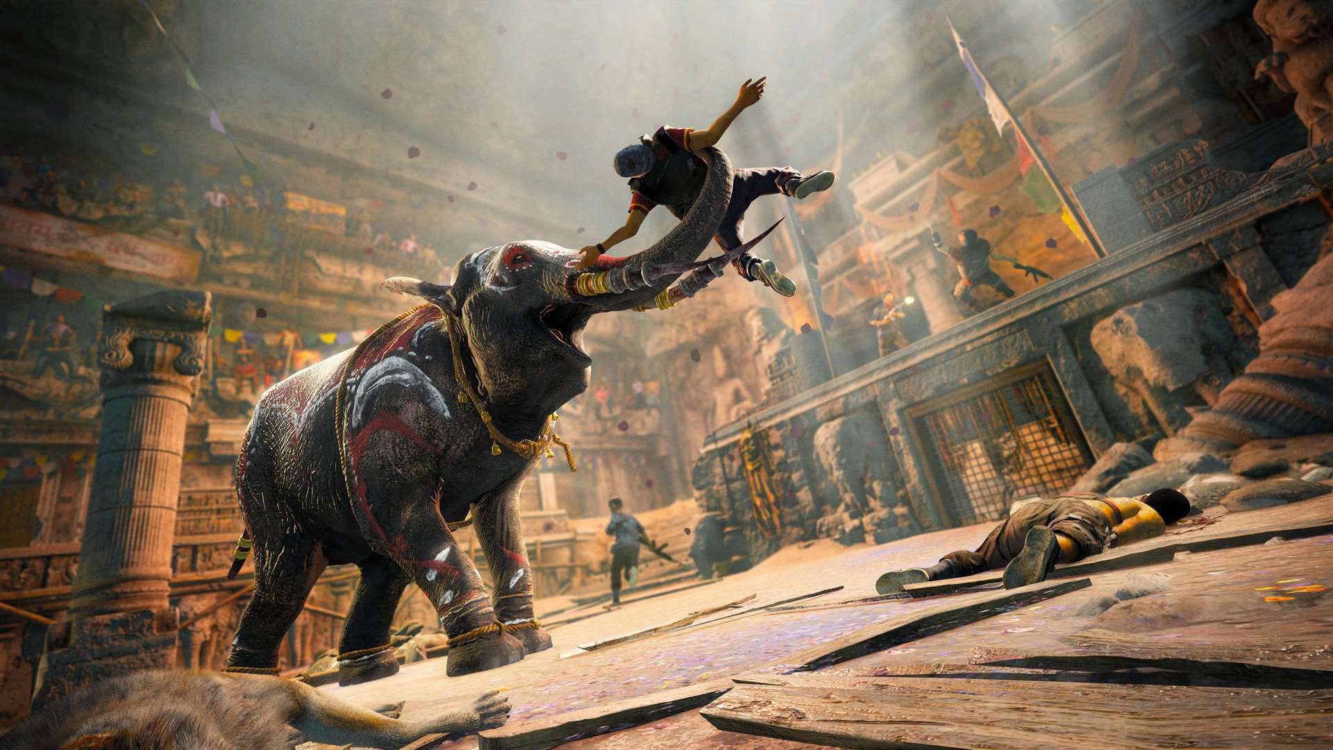 An elephant throws a person into the air inside a stone-walled area.