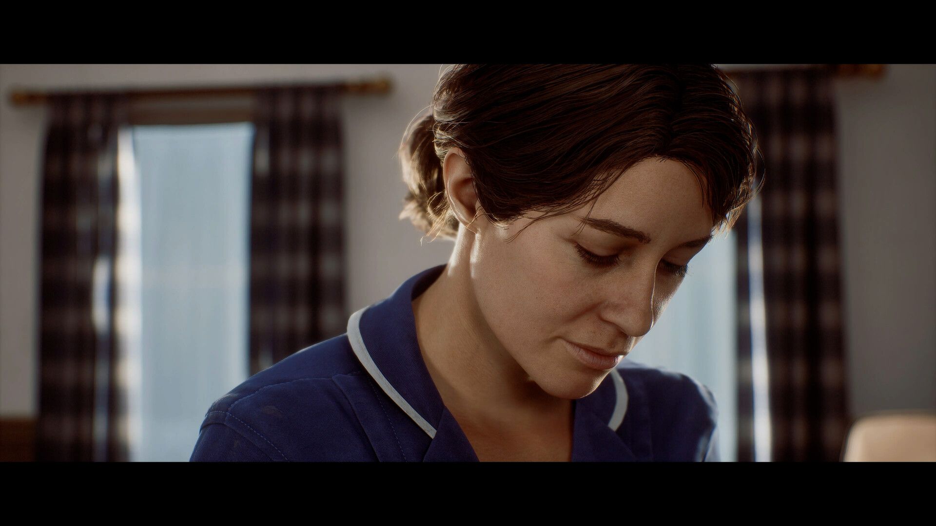 Zoe wears a dark medical uniform and looks downwards.
