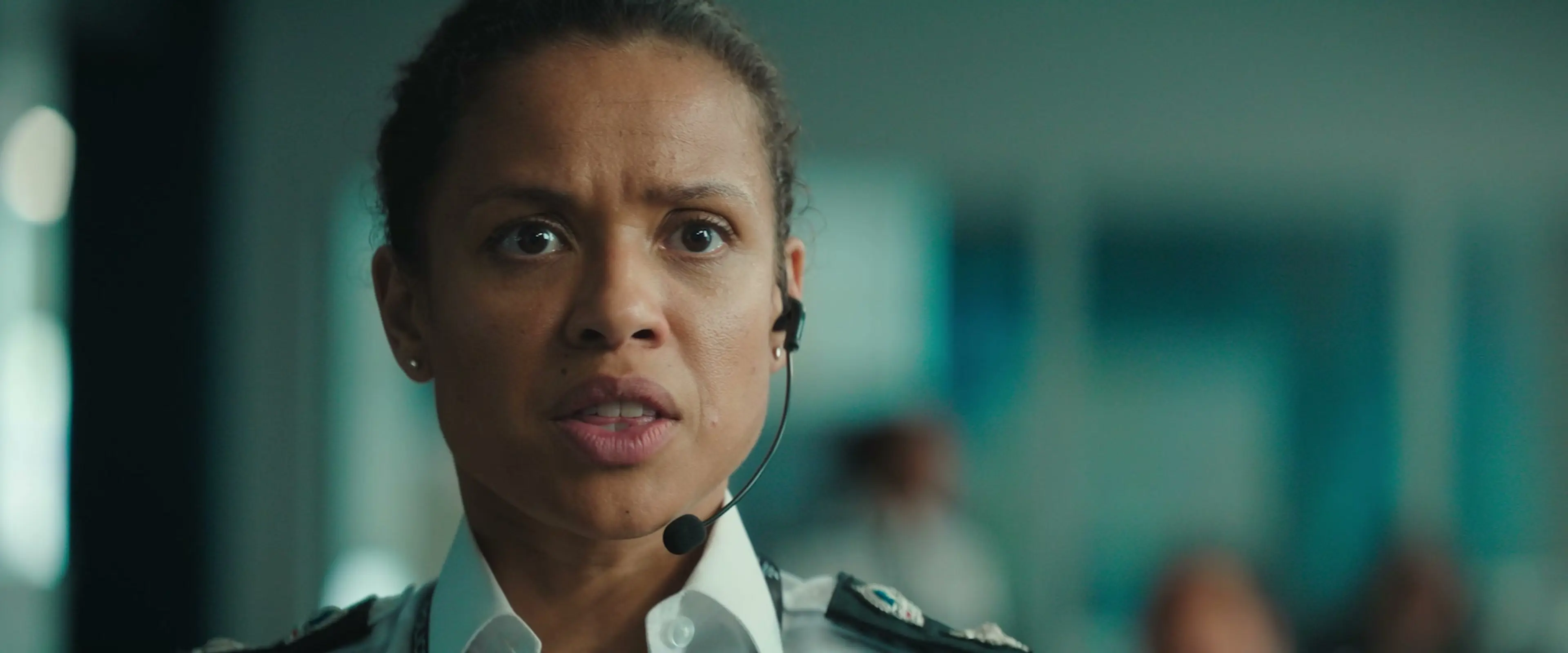 Gugu Mbatha-Raw as police chief Zuzana, wearing a headset in the police control room.