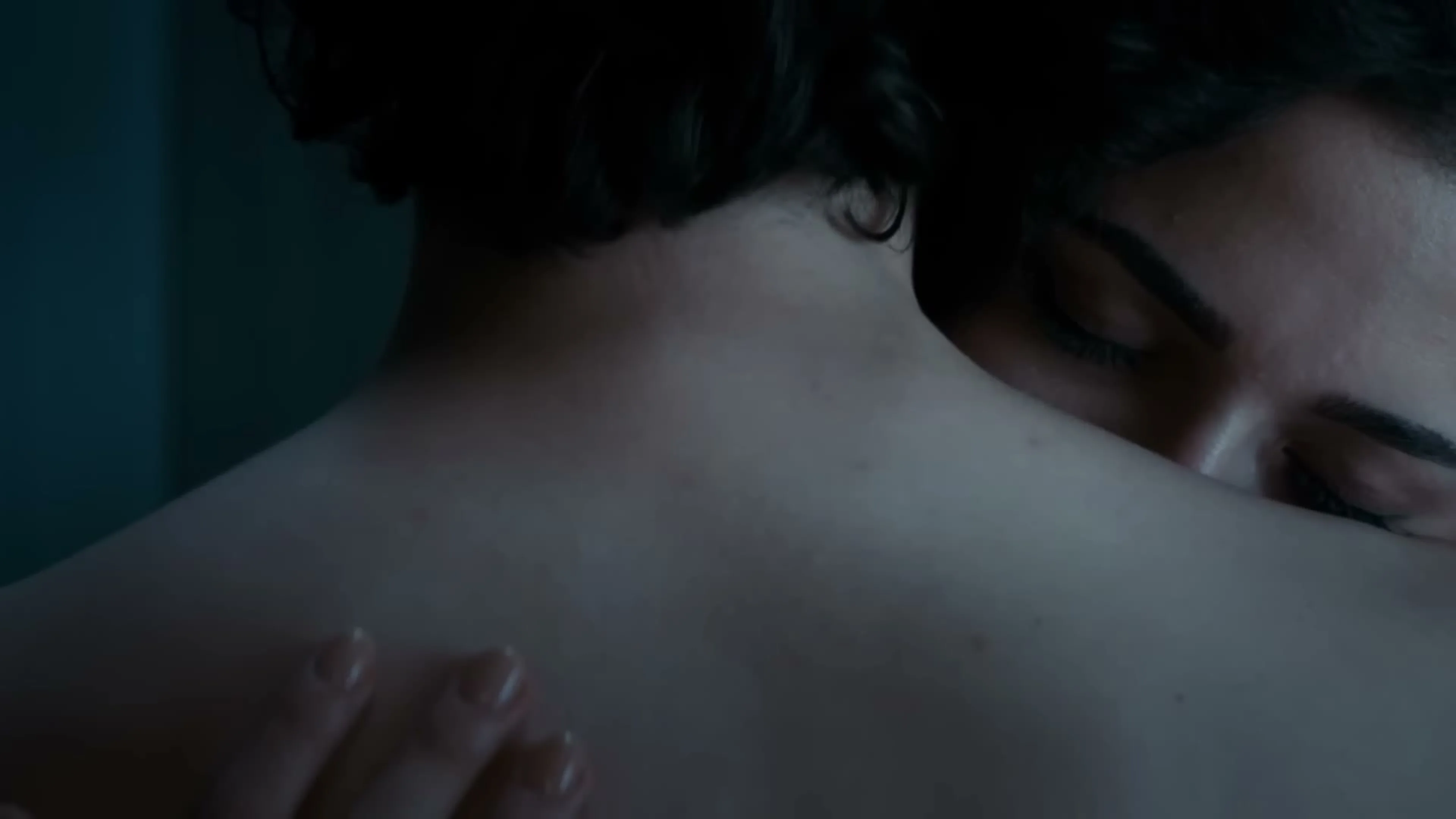 Farasha and Faris embrace in a softly lit scene from Geister.