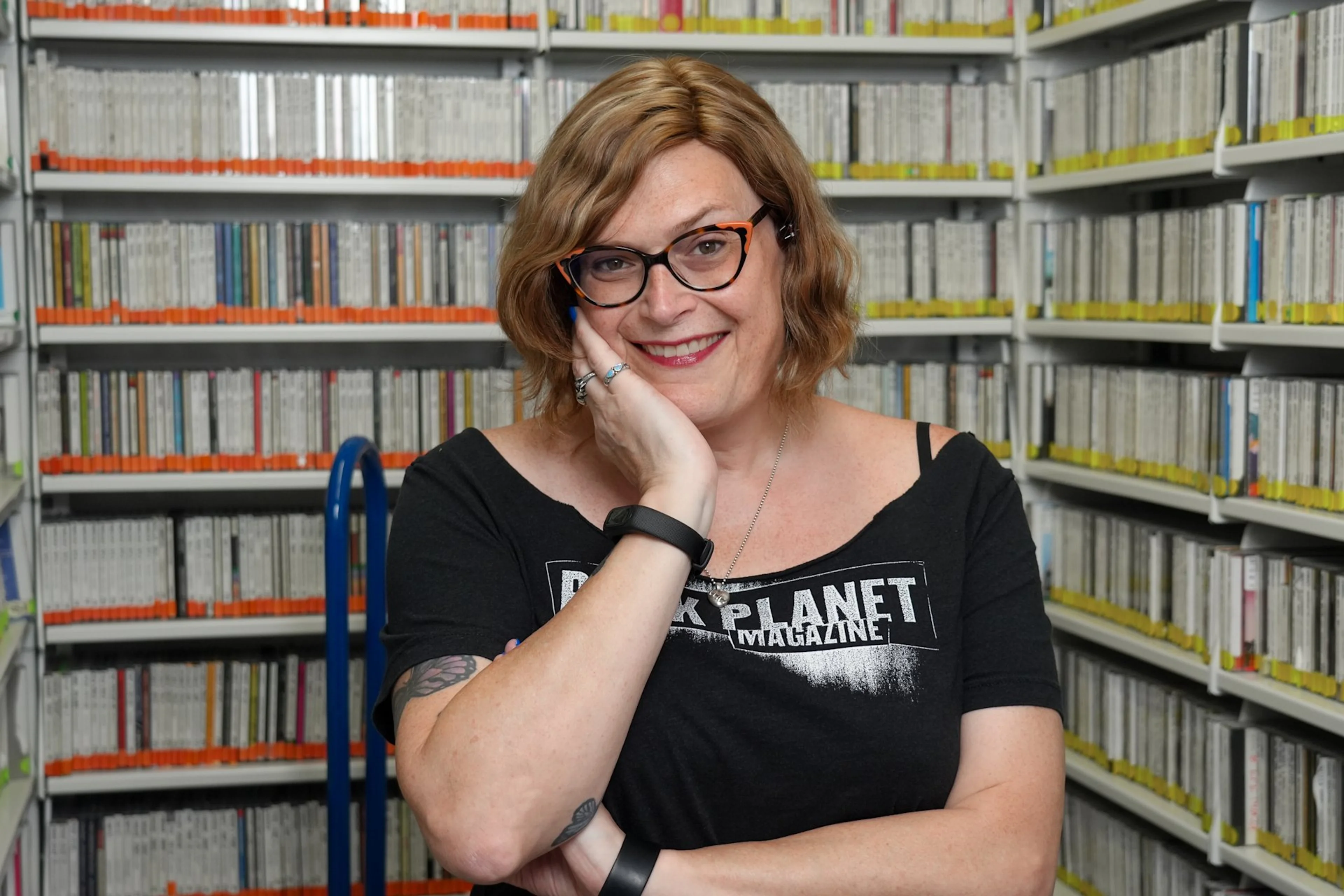 Lilly Wachowski seated in front of a dark curtain during a 2026 KCRW interview.