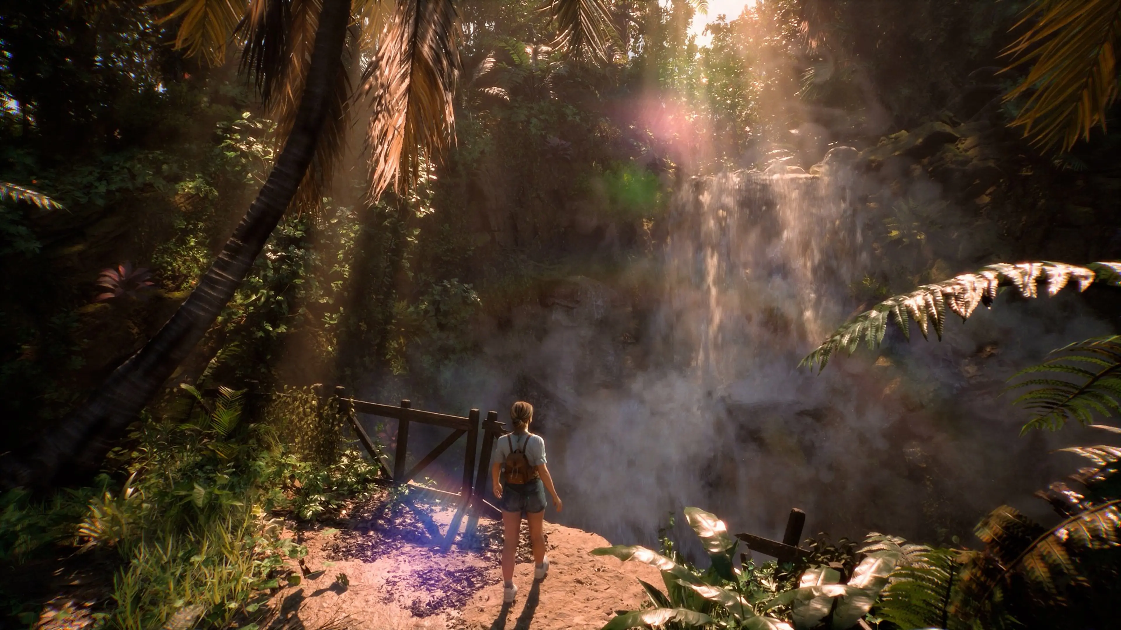 A Dead True crew member stands beside a tropical waterfall on Akishima Island in Until Dawn 2.